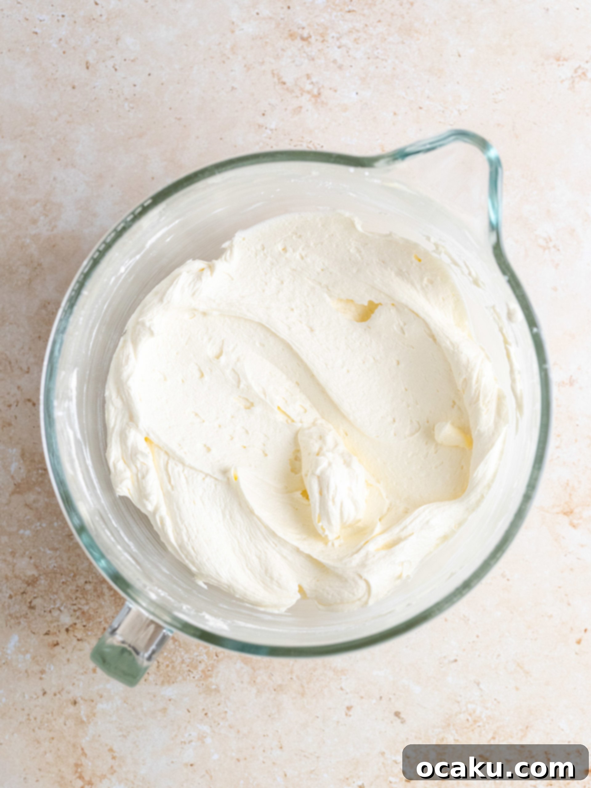 Smooth, glossy homemade chocolate fudge sauce cooling in a bowl.