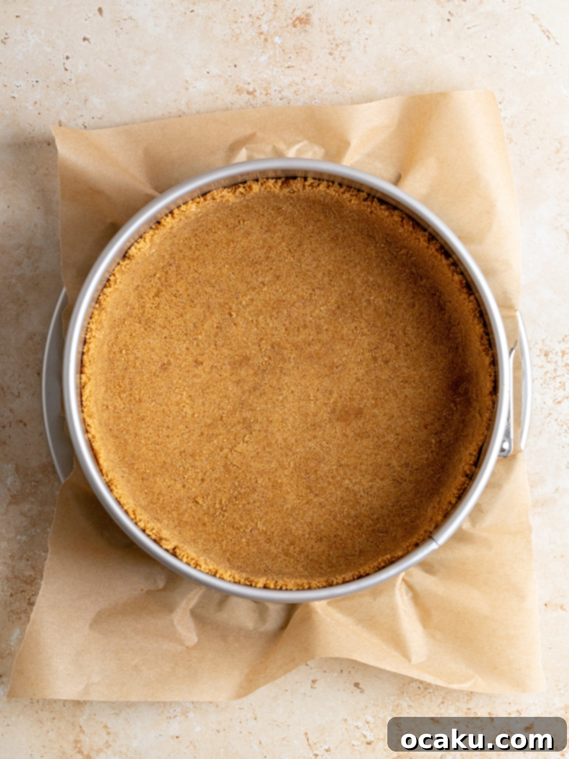 Close-up of the prepared cheesecake crust, perfectly pressed into a springform pan.