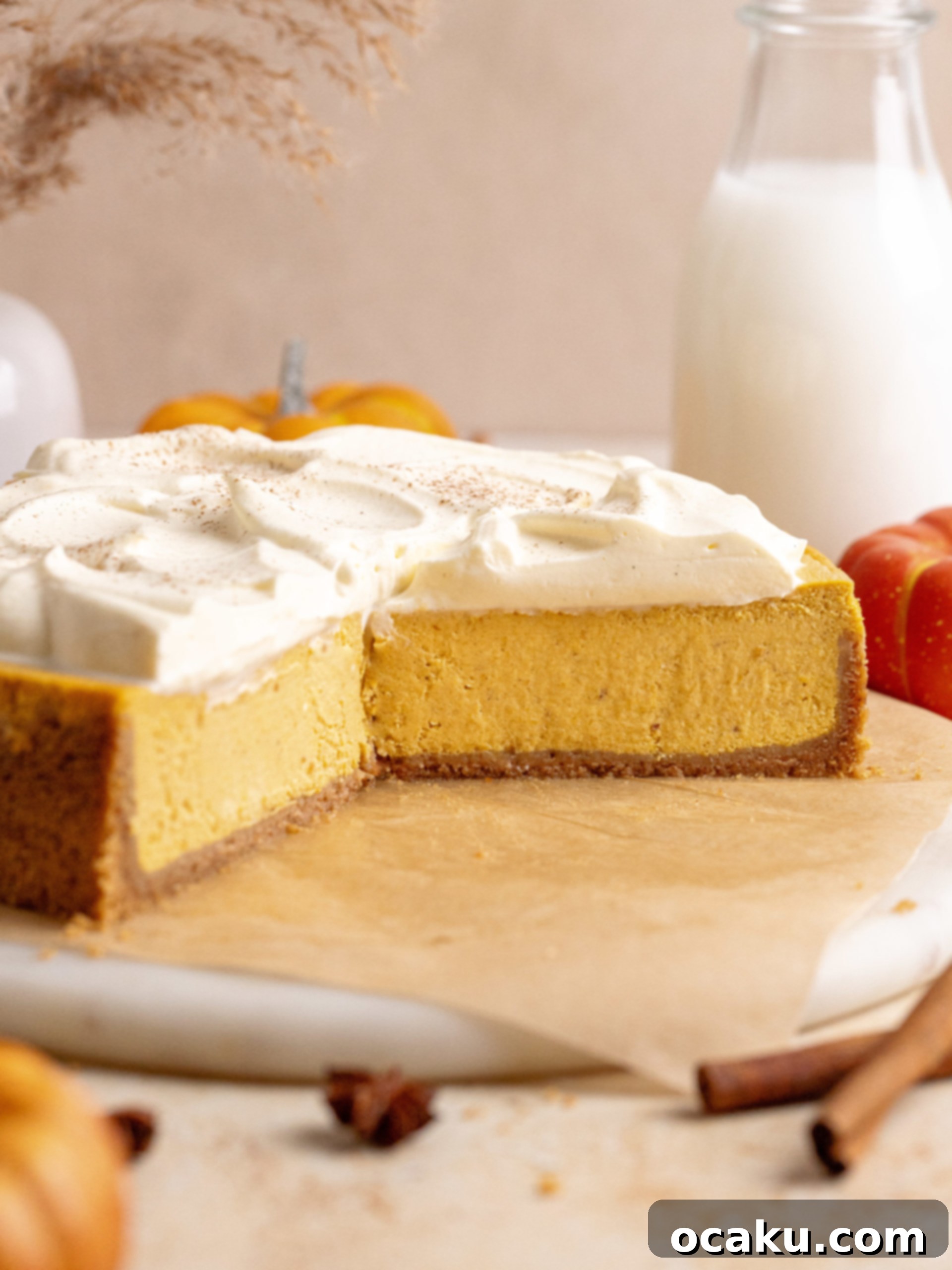 A stunning full view of the pumpkin cheesecake on a serving plate, highlighting its perfect form and inviting texture.
