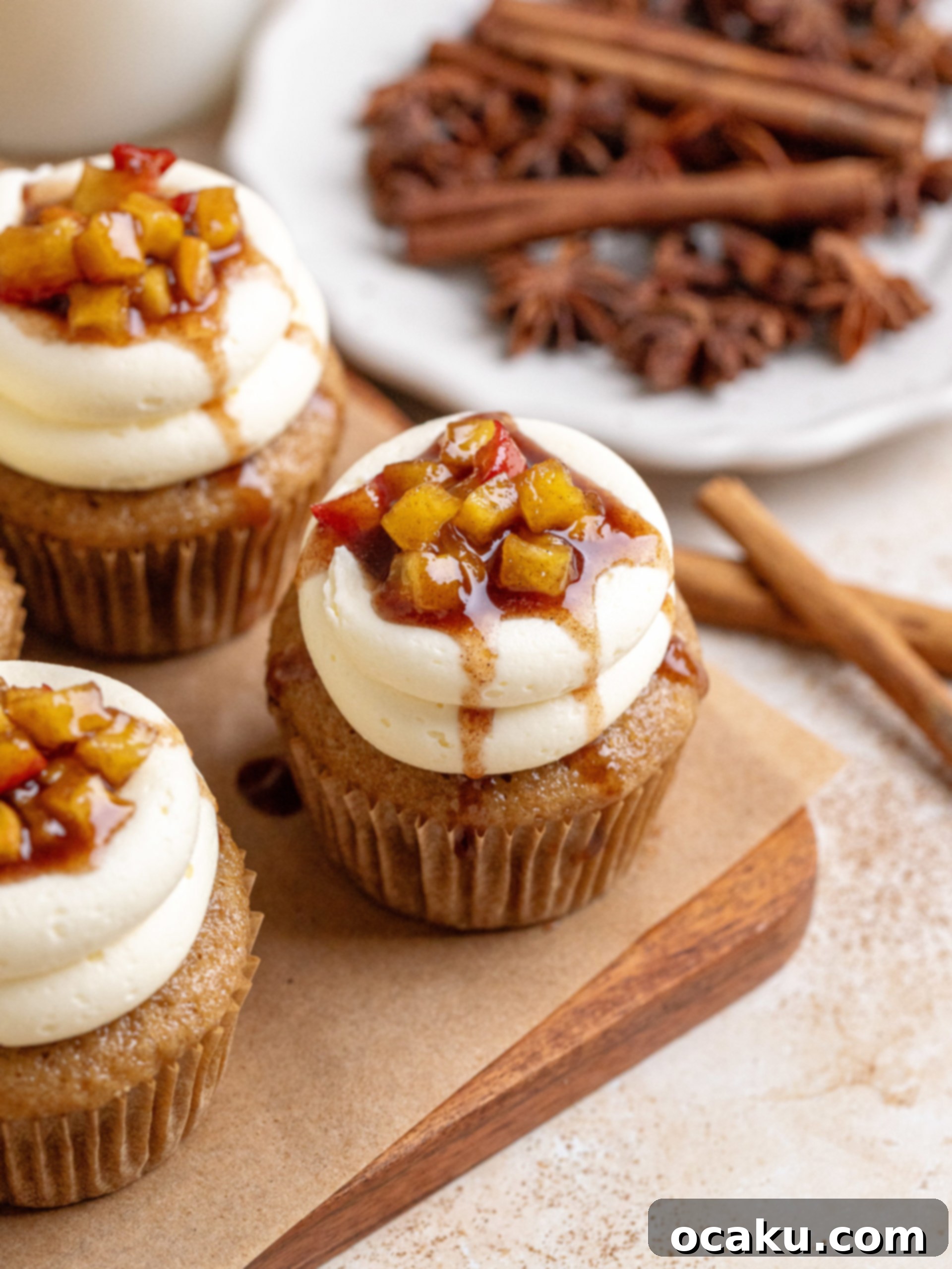 A beautifully arranged plate of Apple Pie Cupcakes, showing the vanilla buttercream and a hint of apple pie filling.