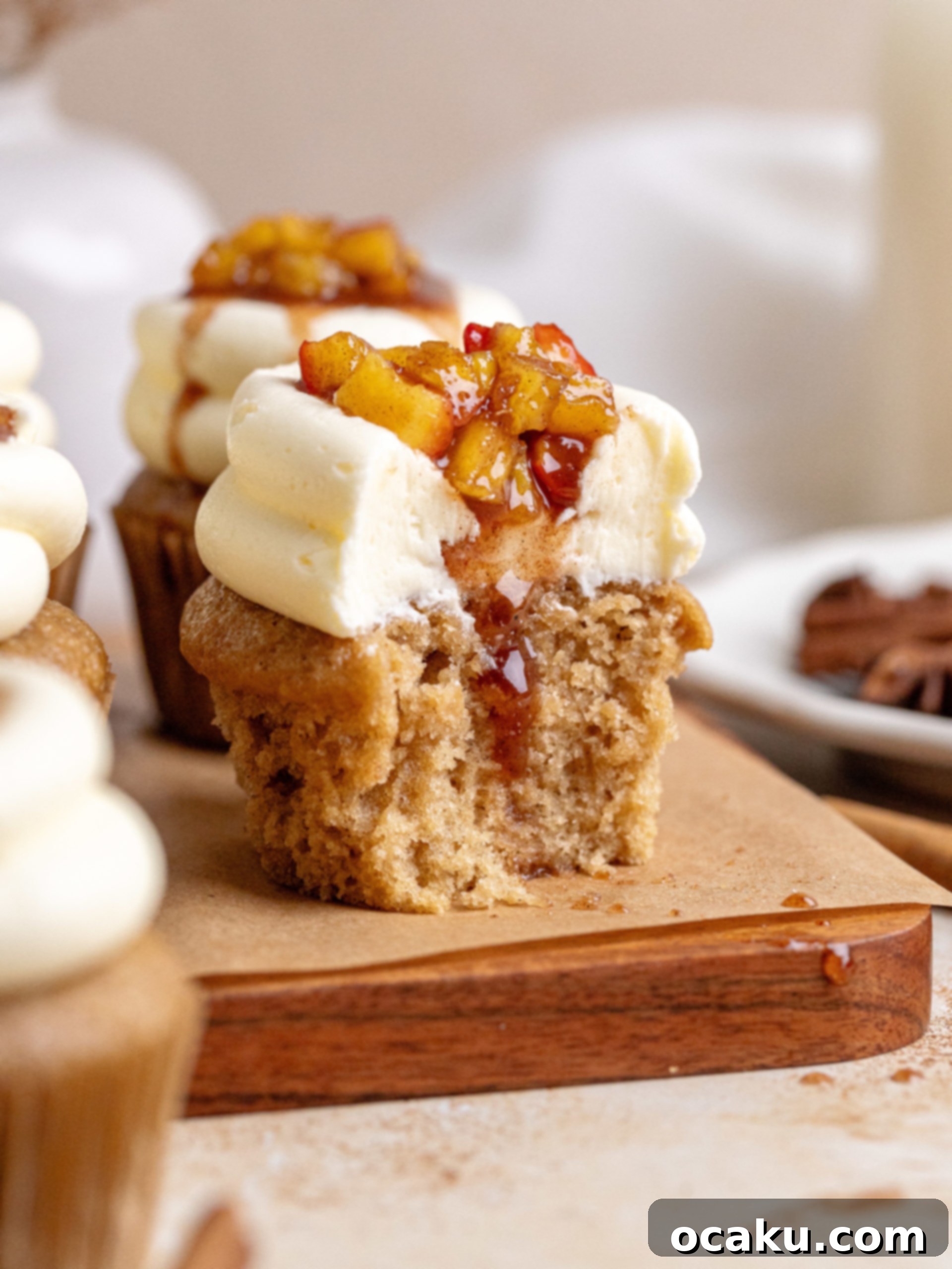 Close-up of a filled Apple Pie Cupcake, showing the creamy buttercream and apple filling.
