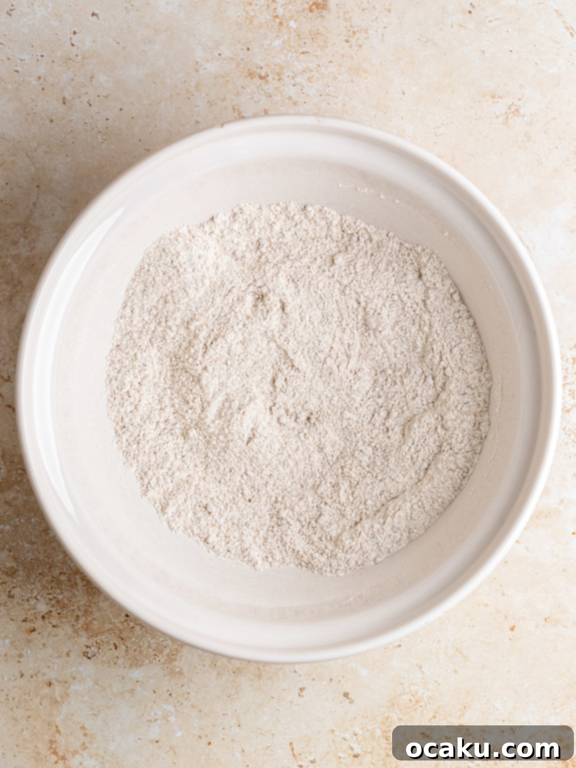 Step-by-step image of mixing dry ingredients for cupcakes.