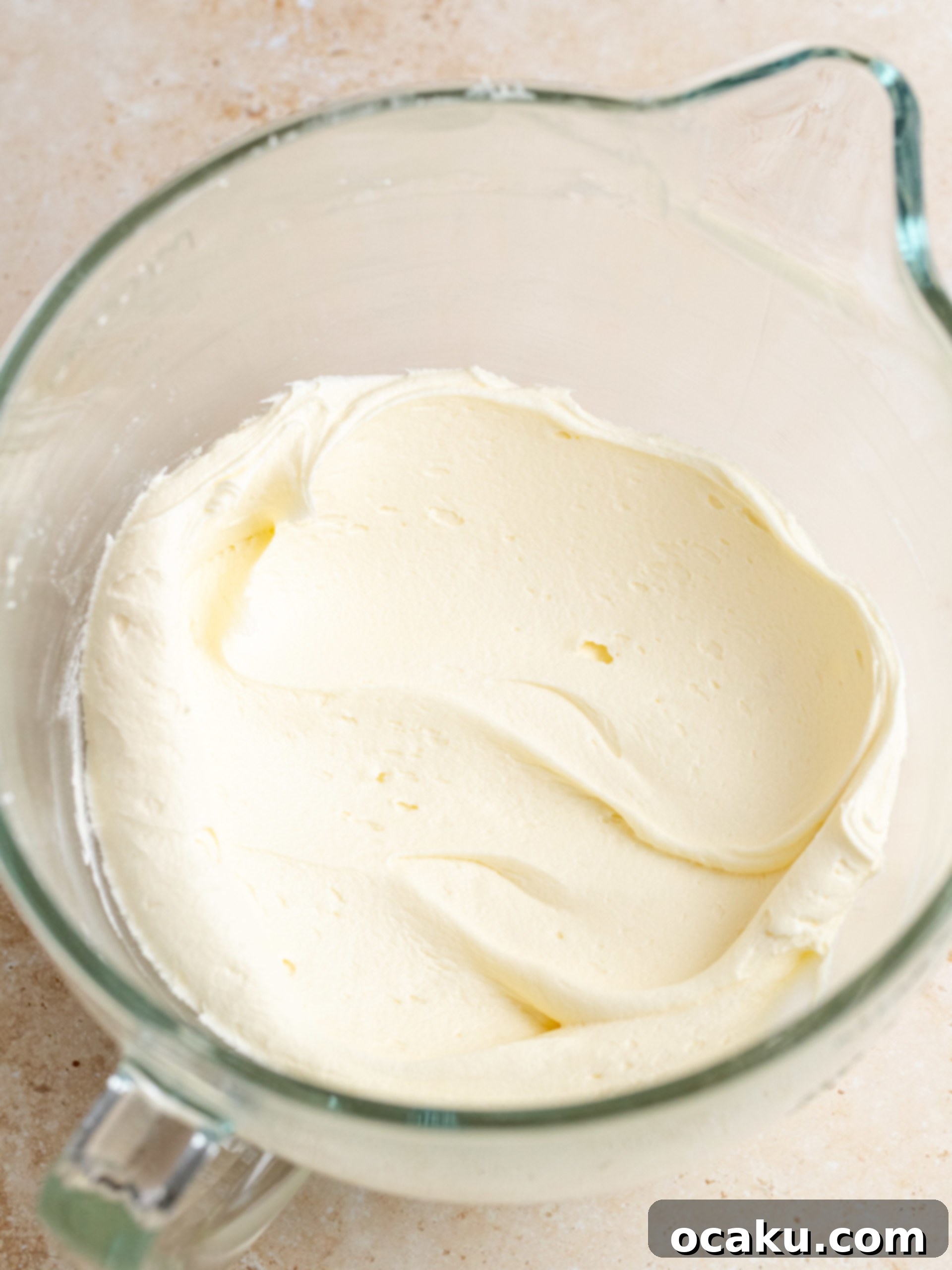 Step-by-step image of piping buttercream onto cupcakes.