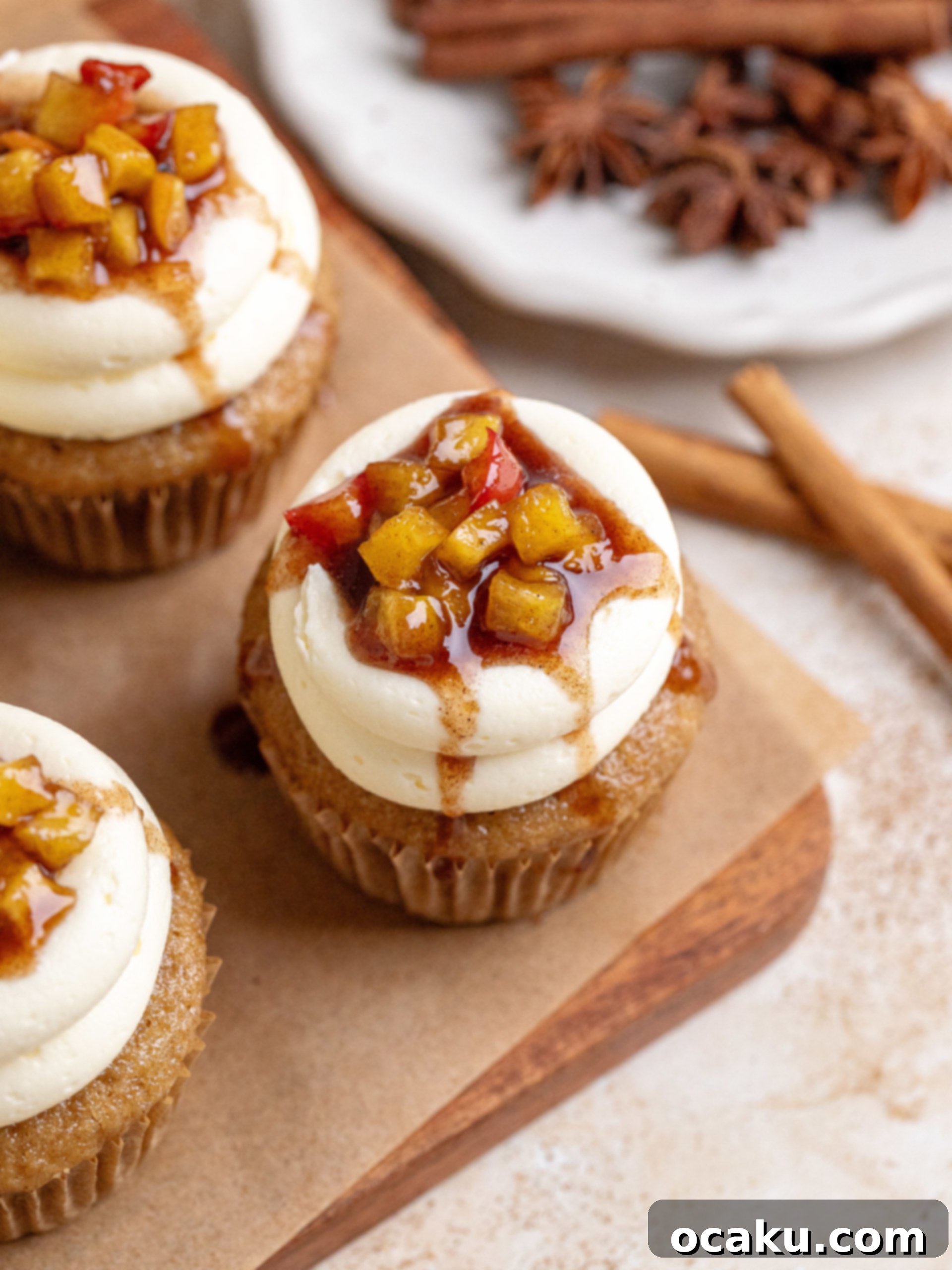 A finished Apple Pie Cupcake with a spoon, highlighting the delicious filling.
