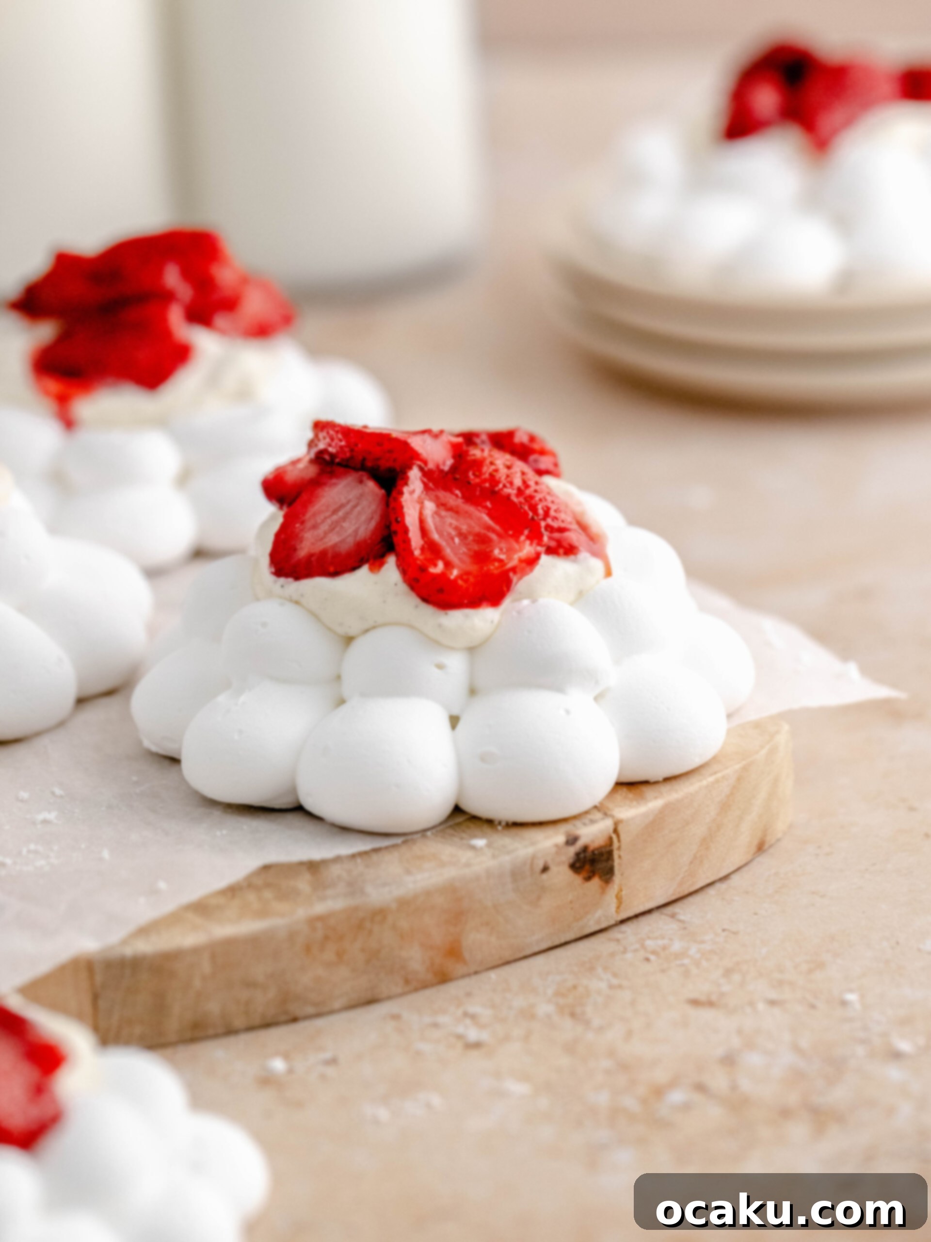 A close-up of a baked strawberry meringue nest, showcasing the layers of crisp meringue, fluffy cream, and juicy baked strawberries, ready to be served.