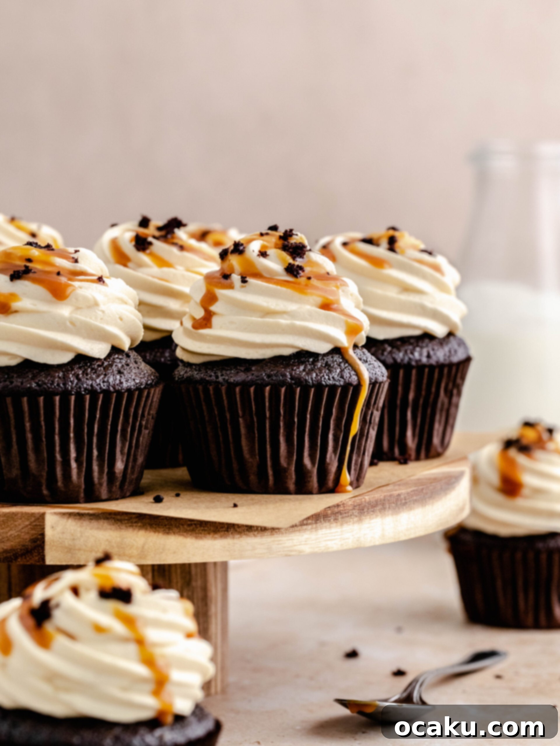 Overhead view of several caramel filled chocolate cupcakes on a serving tray.