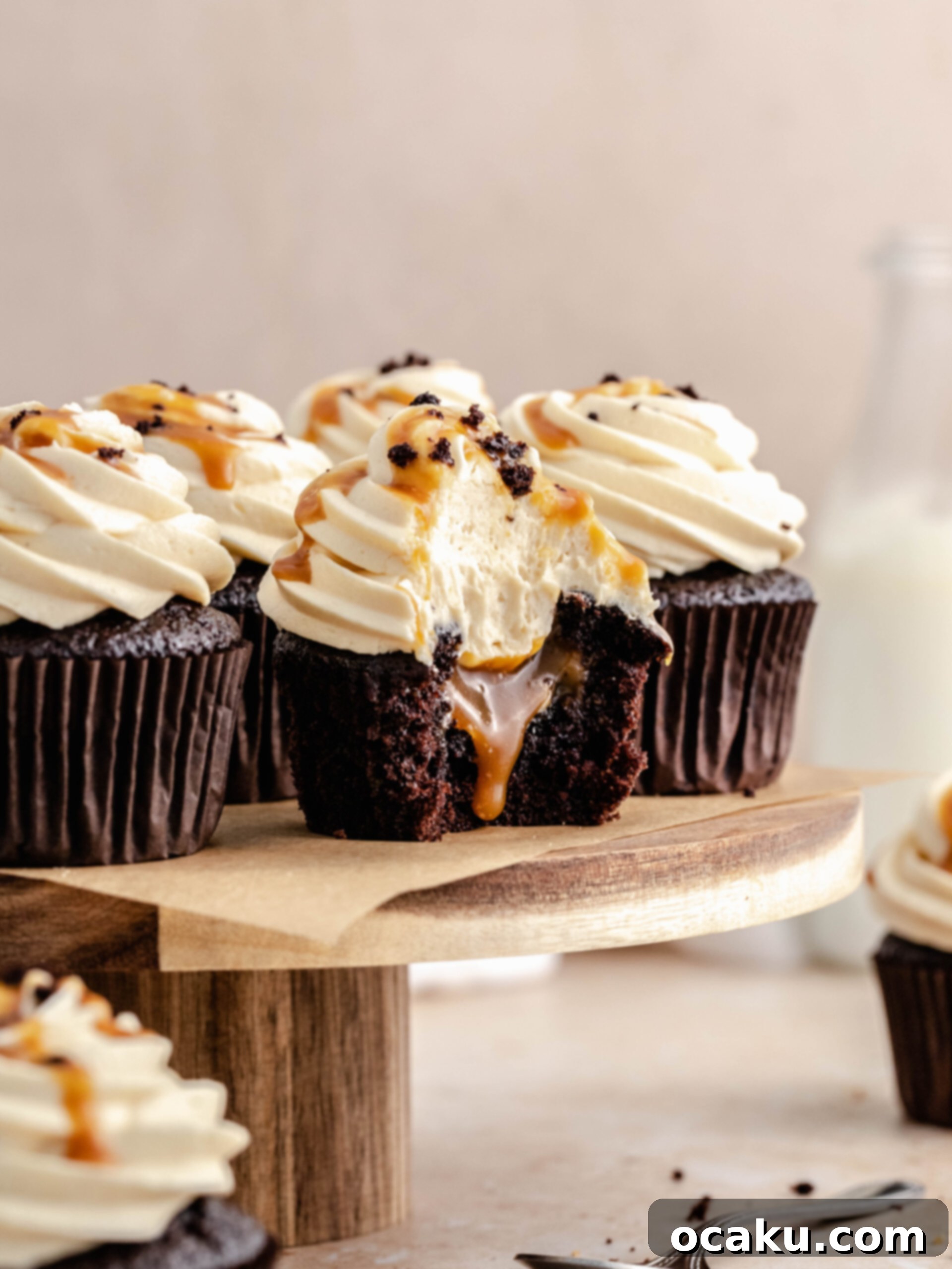 A delicious caramel filled cupcake with a bite taken out, revealing the gooey caramel center.