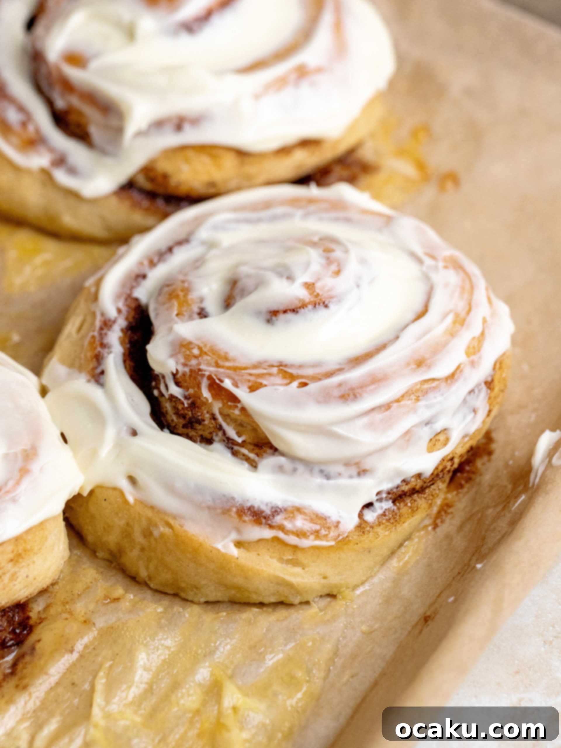 Close-up of a giant cinnamon roll, showcasing its soft interior, cinnamon swirl, and creamy frosting.