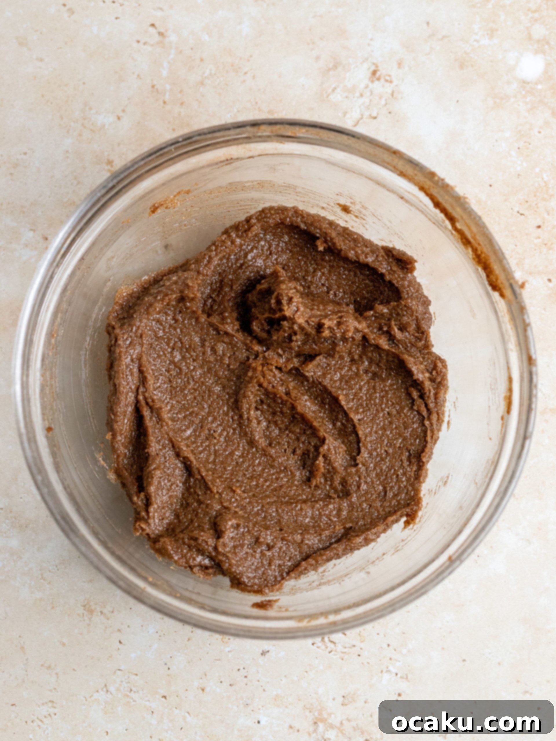 Two giant cinnamon rolls freshly frosted with cream cheese icing, glistening and ready to eat.