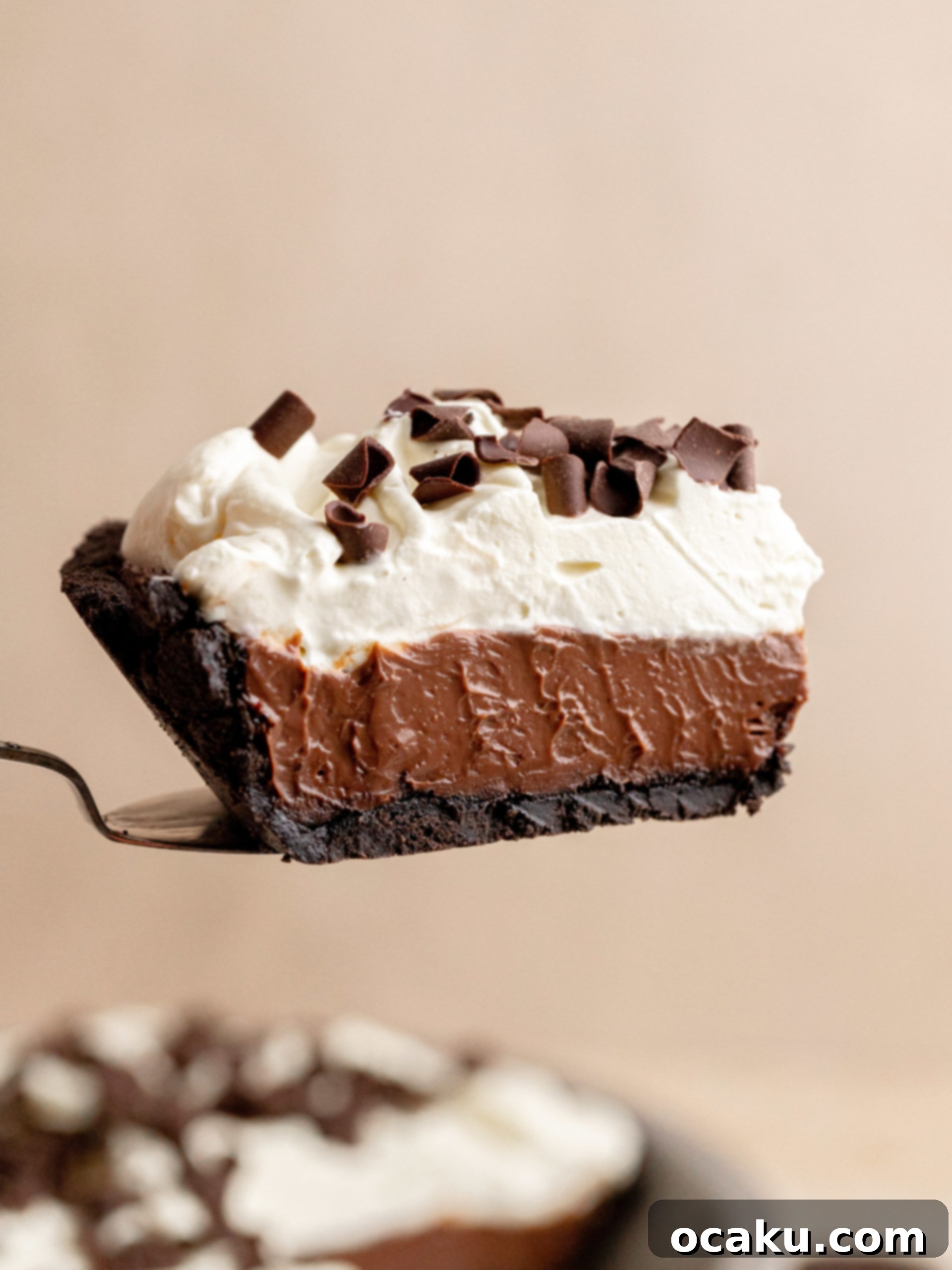 A slice of Chocolate Coffee Pie with whipped cream topping and a crunchy Oreo crust.