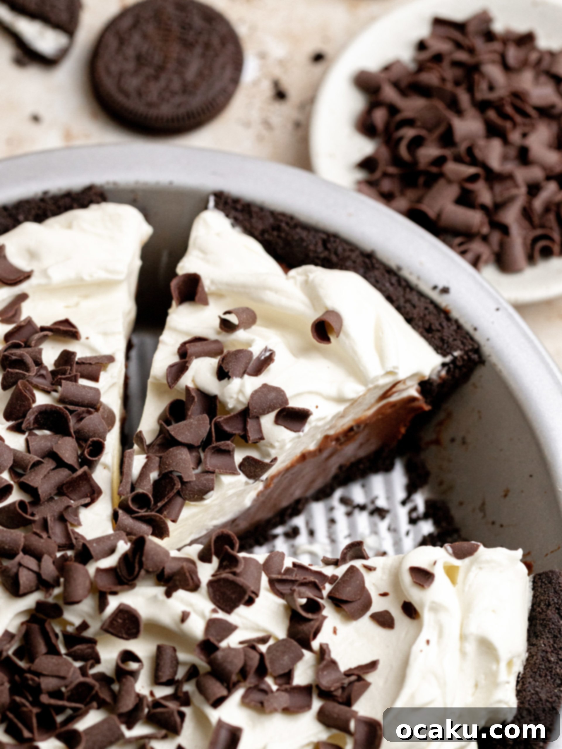 Close-up of the silky chocolate coffee pastry cream being poured into the Oreo crust.