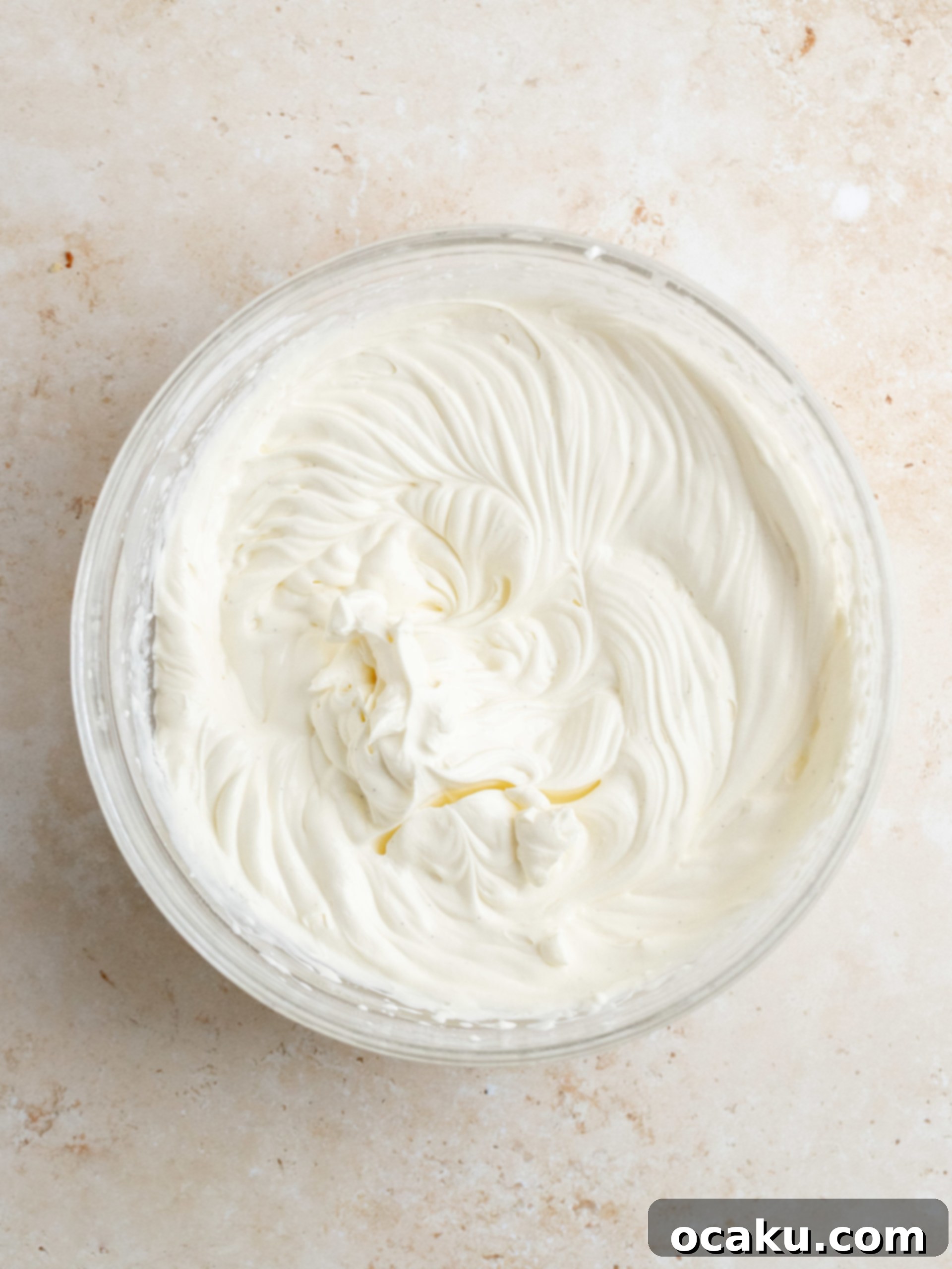 Whipped mascarpone cream being piped onto the chilled pie.