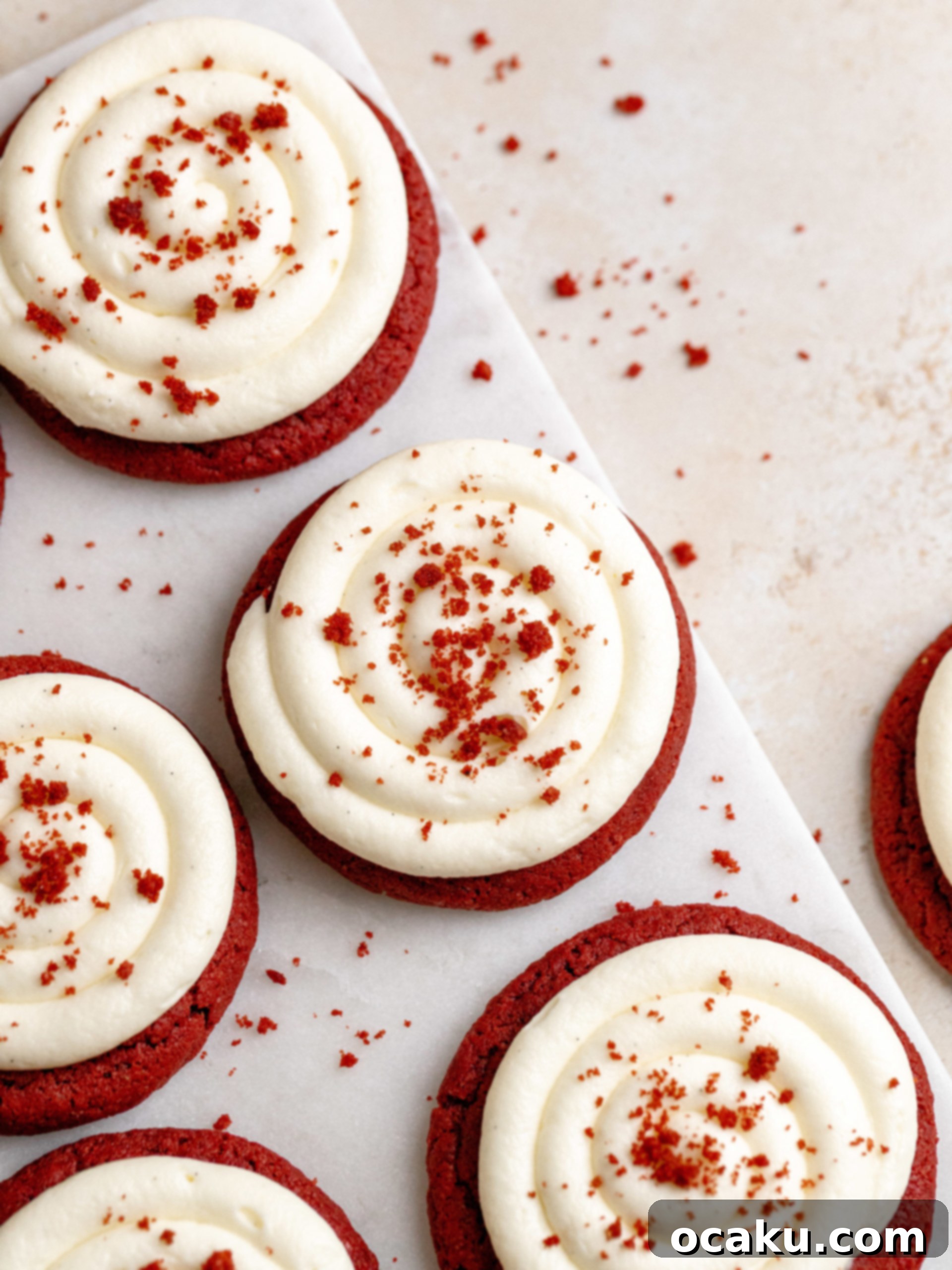 Freshly baked Red Velvet Cookies with Cream Cheese Frosting on a cooling rack