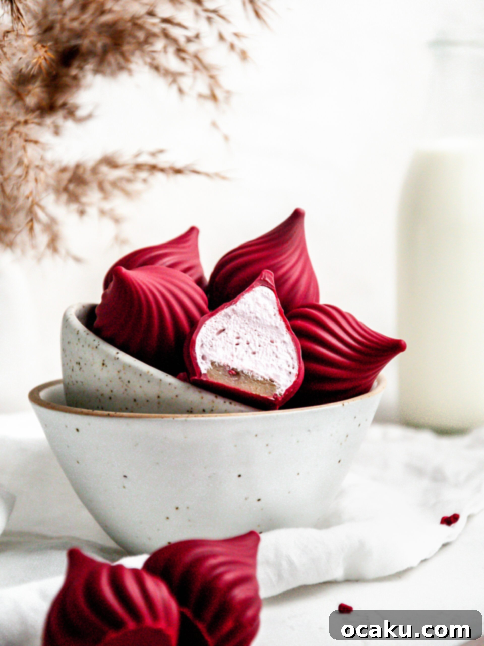 Delicate raspberry cream puffs in a serving bowl, showcasing their vibrant color and elegant design.