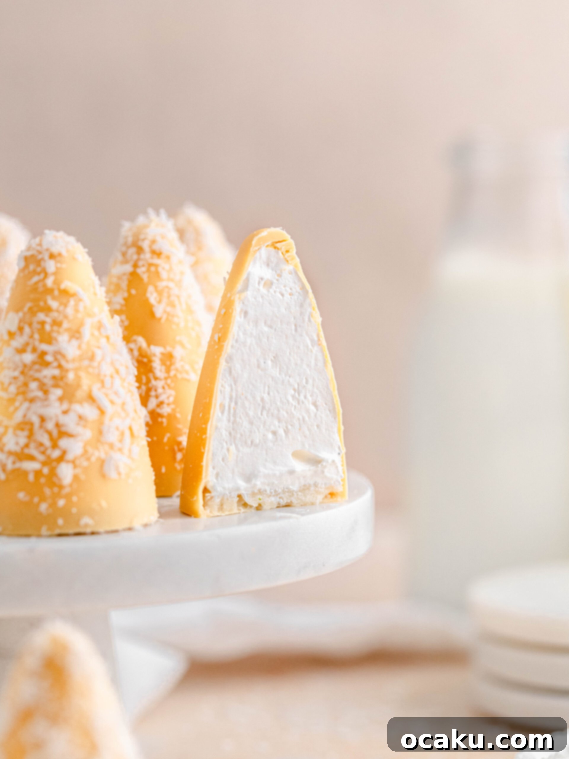 passion fruit and coconut cream puffs cut in half, showing the fluffy marshmallow and marzipan base.