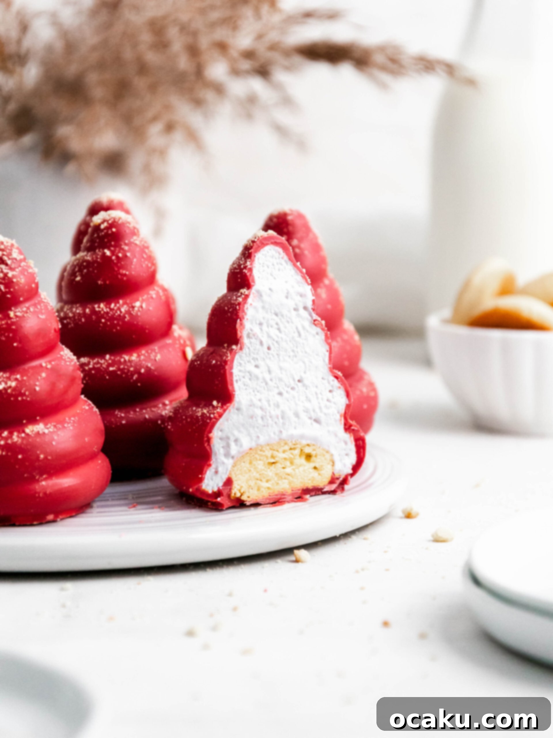 Strawberry Cookie Dream Puffs 3 A strawberry and cookie cream puff cut in half, revealing the layers of shortbread cookie, pink marshmallow fluff, and chocolate shell.