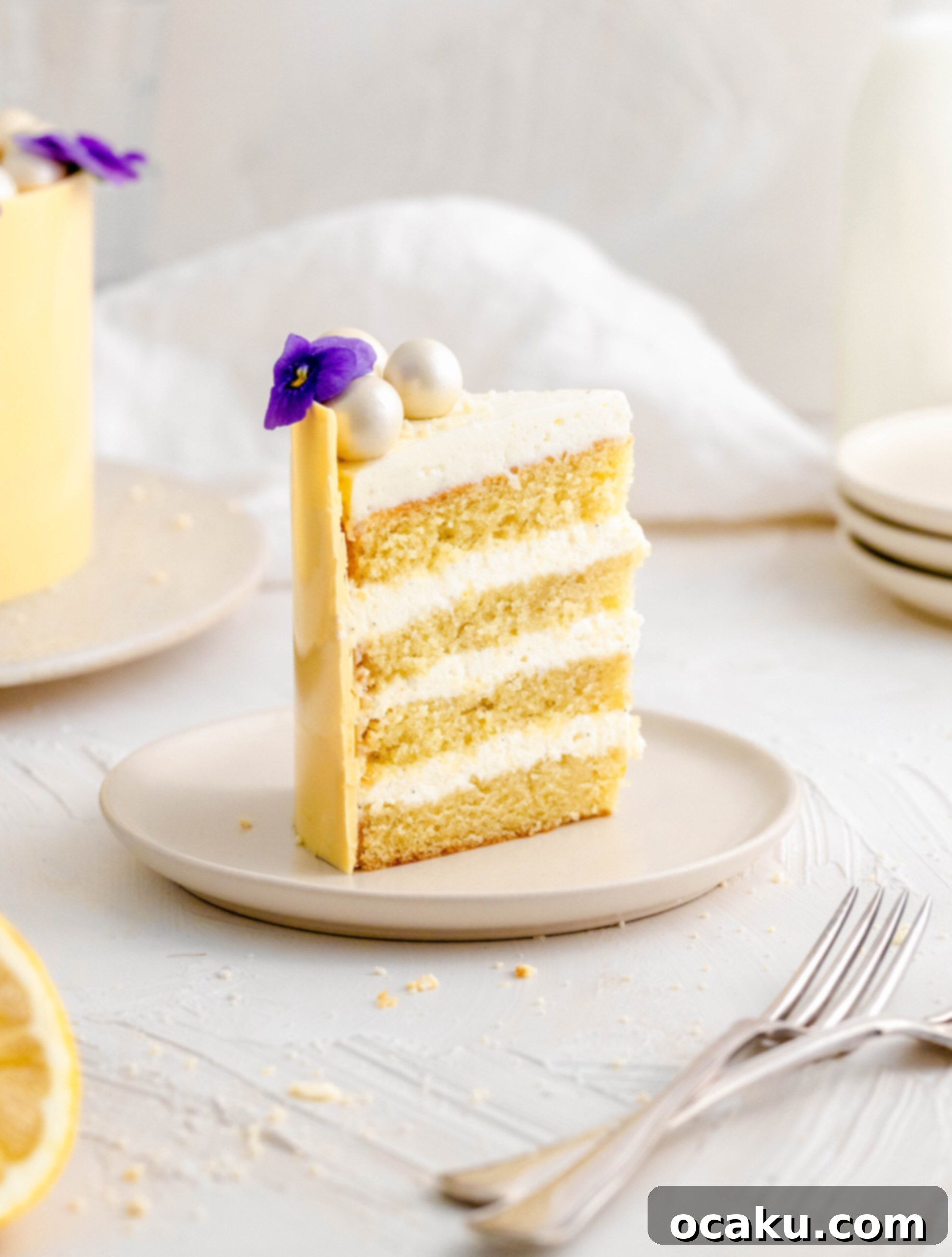 A perfectly portioned slice of lemon and mascarpone cake, revealing its delicate layers and creamy filling, served on a pristine white plate.