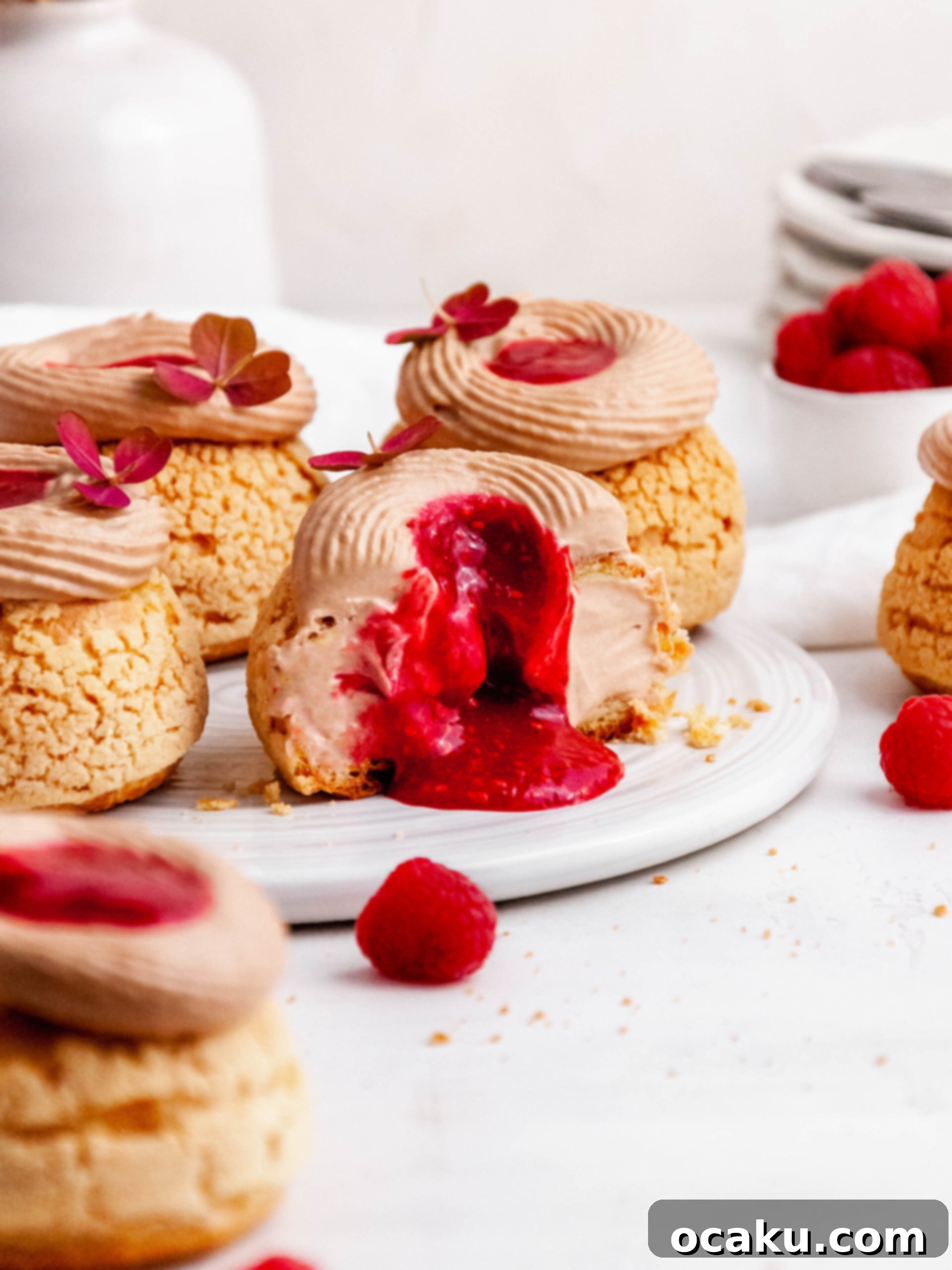 Close-up of a perfectly baked Choux au Craquelin, showing the delicate cracks in the craquelin topping and a hint of the creamy filling.