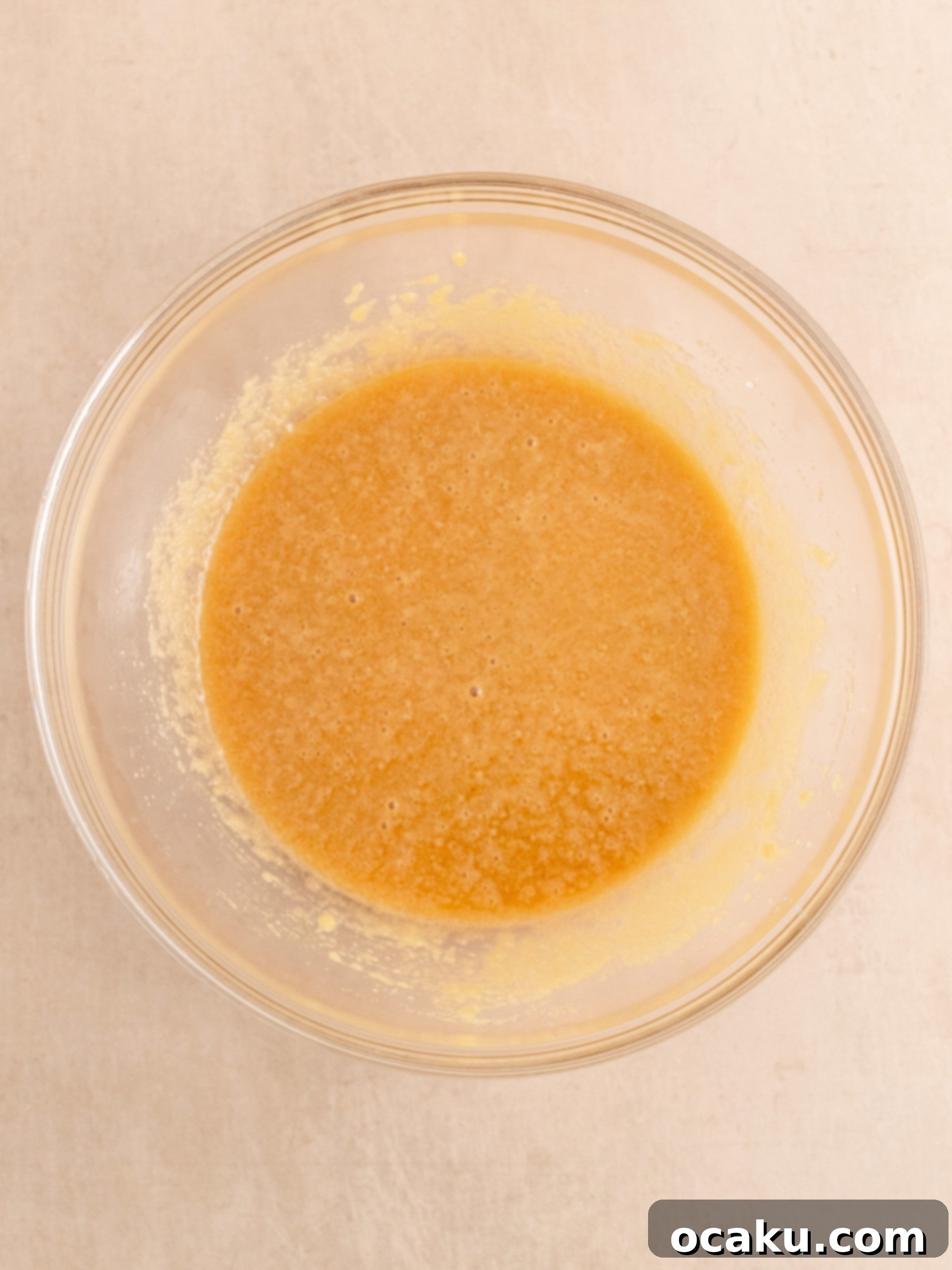 Biscoff Dream Cake 4 Step-by-step image showing Biscoff cake batter being mixed in a bowl.