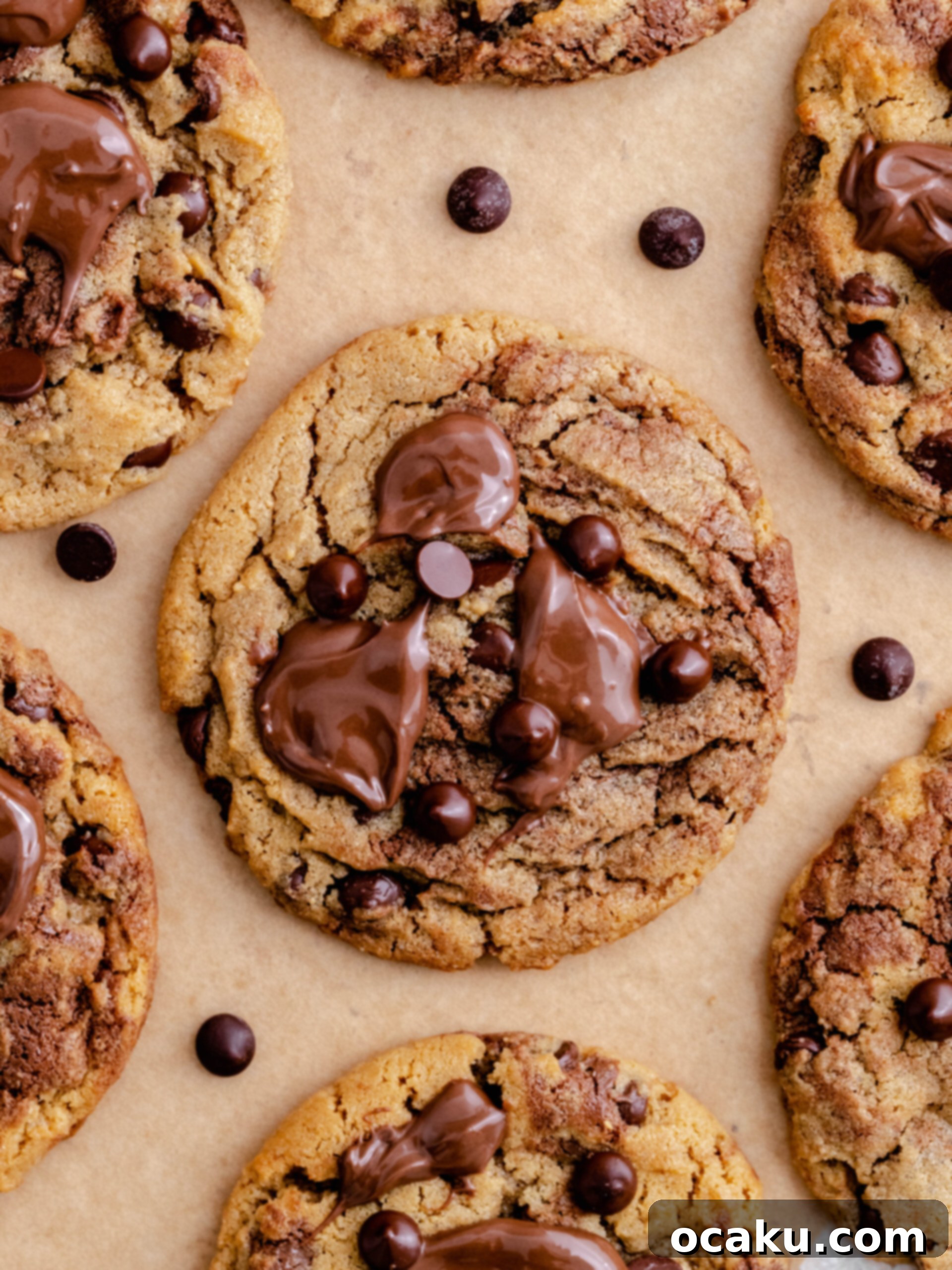Nutella Peanut Butter Swirl Cookies 12 A stack of golden-brown Nutella peanut butter cookies, adorned with generous dollops of Nutella on top, ready to be enjoyed.