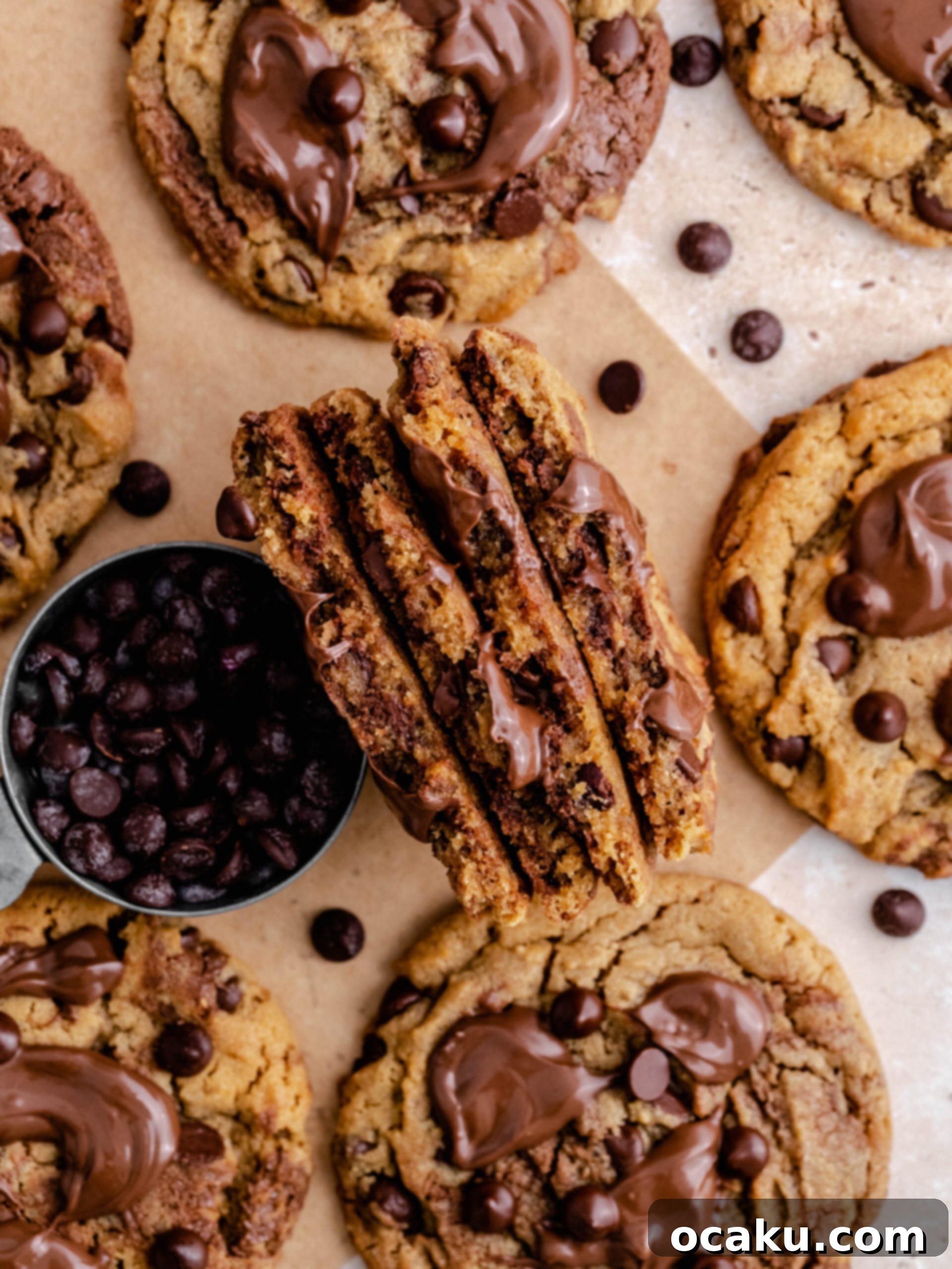 Nutella Peanut Butter Swirl Cookies 3 A close-up of a Nutella peanut butter cookie broken in half, revealing its soft, chewy center with visible Nutella swirls and chocolate chips.