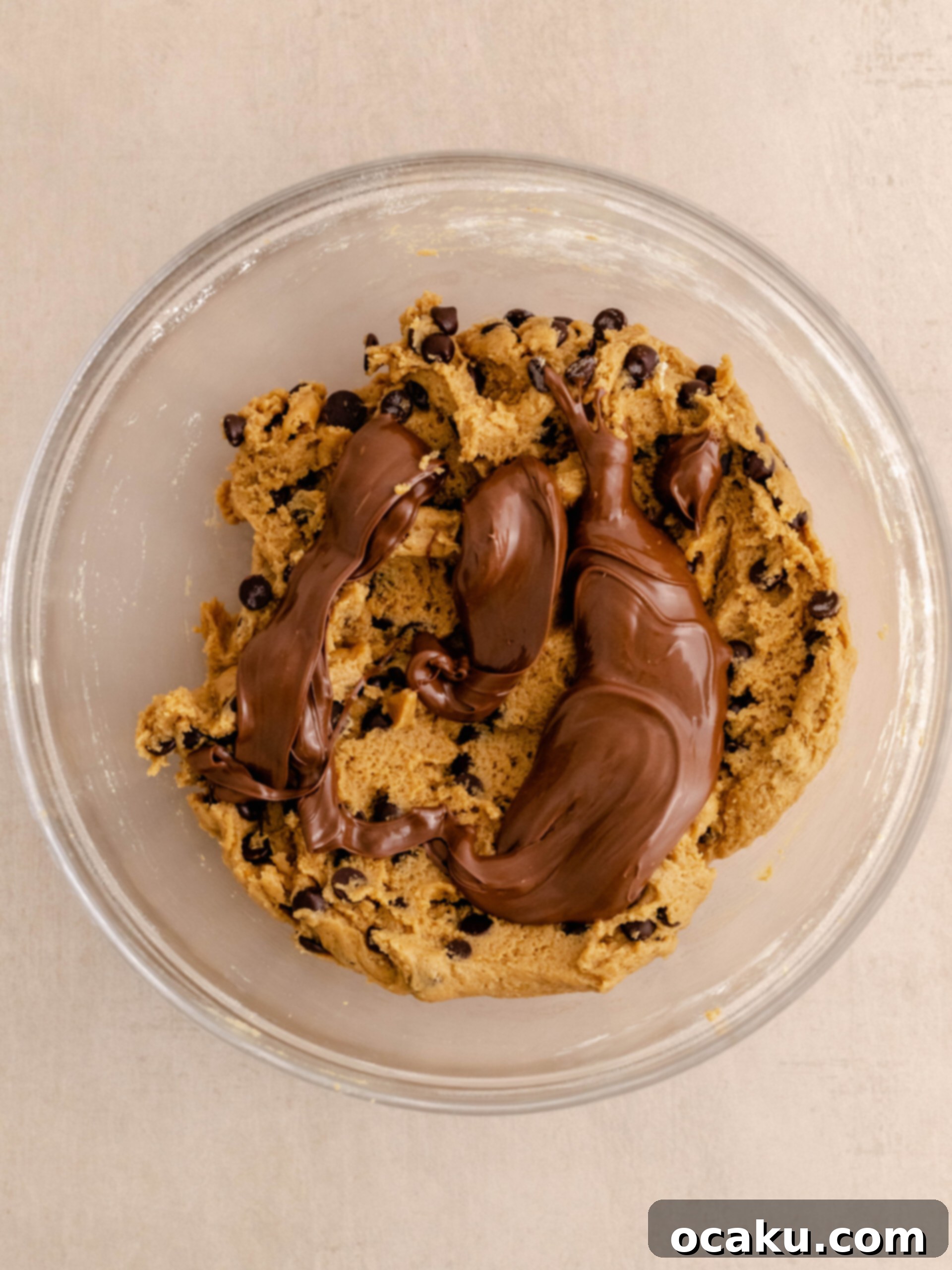 Nutella Peanut Butter Swirl Cookies 8 Dollops of Nutella spread across the surface of the prepared cookie dough, ready for swirling.