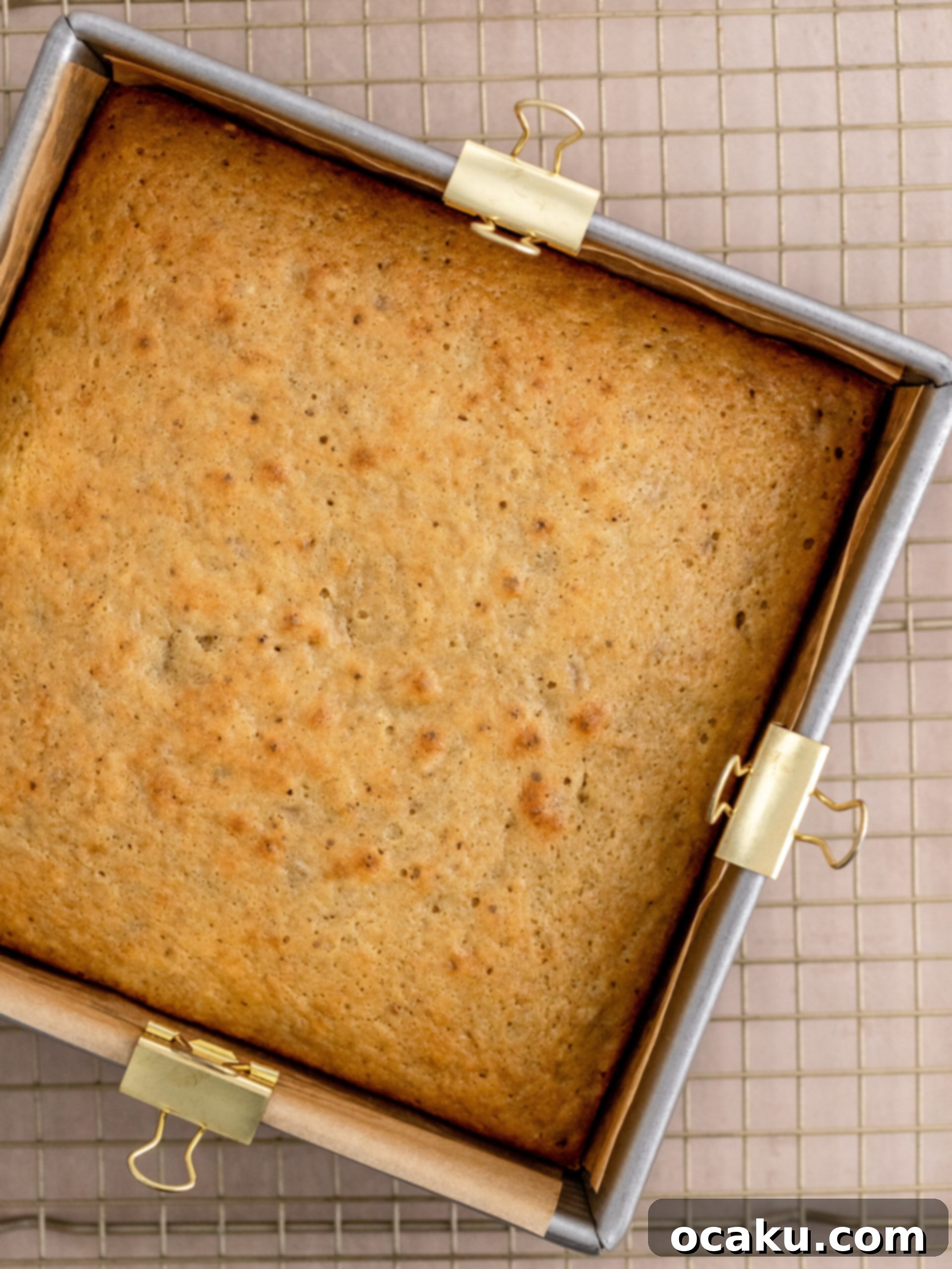 Spreading chocolate buttercream on banana cake