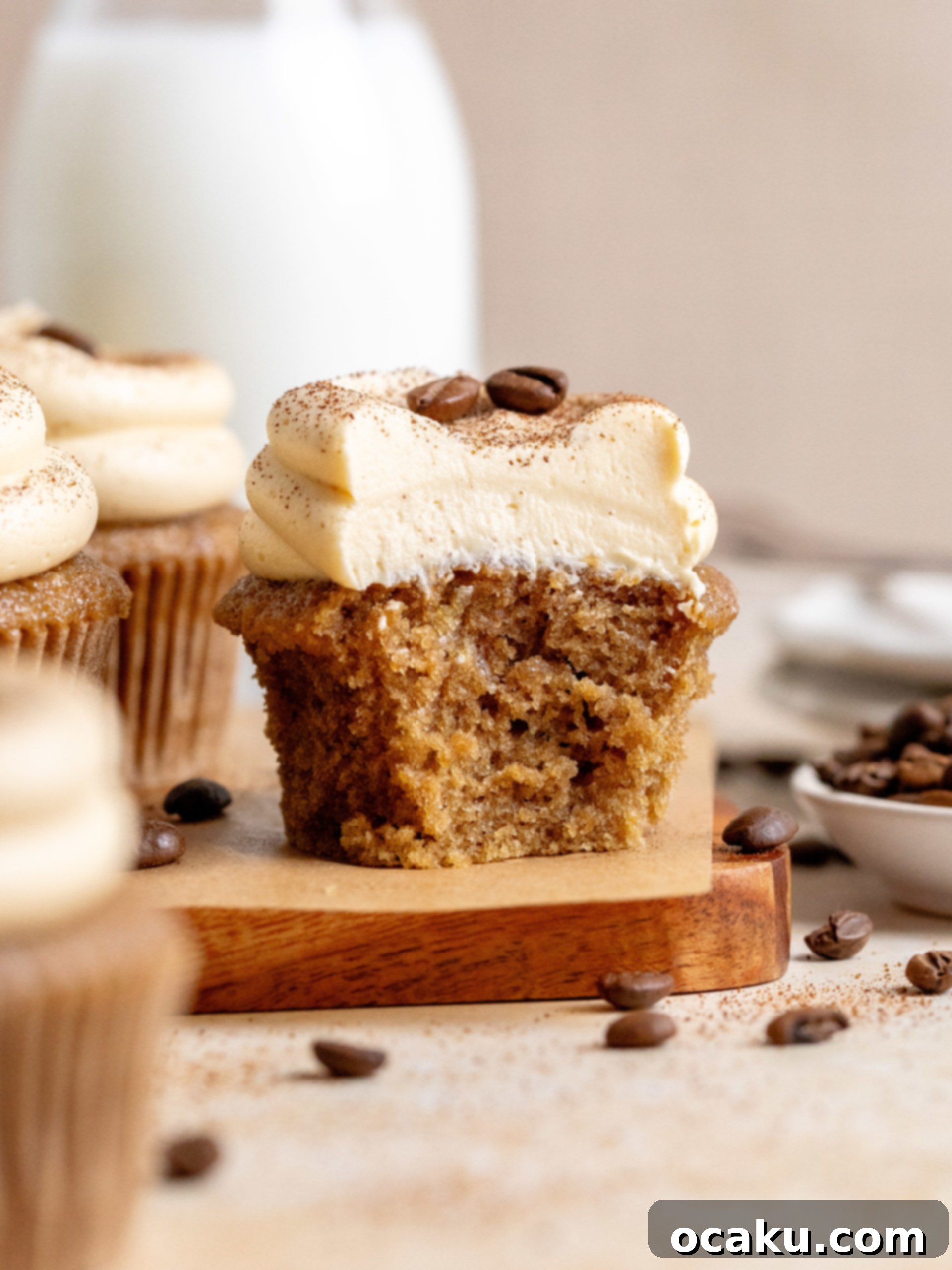 A top-down view of multiple coffee cupcakes garnished with coffee beans.