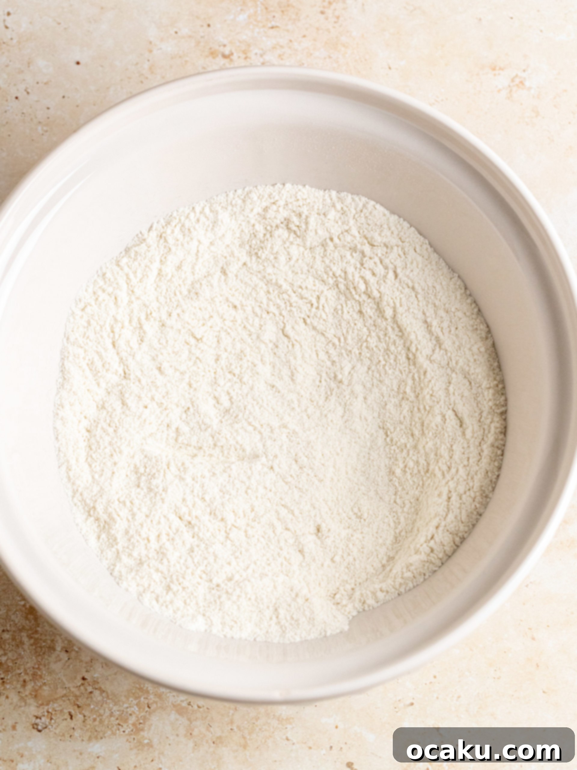 Mixing dry ingredients in a large bowl for coffee cupcakes.