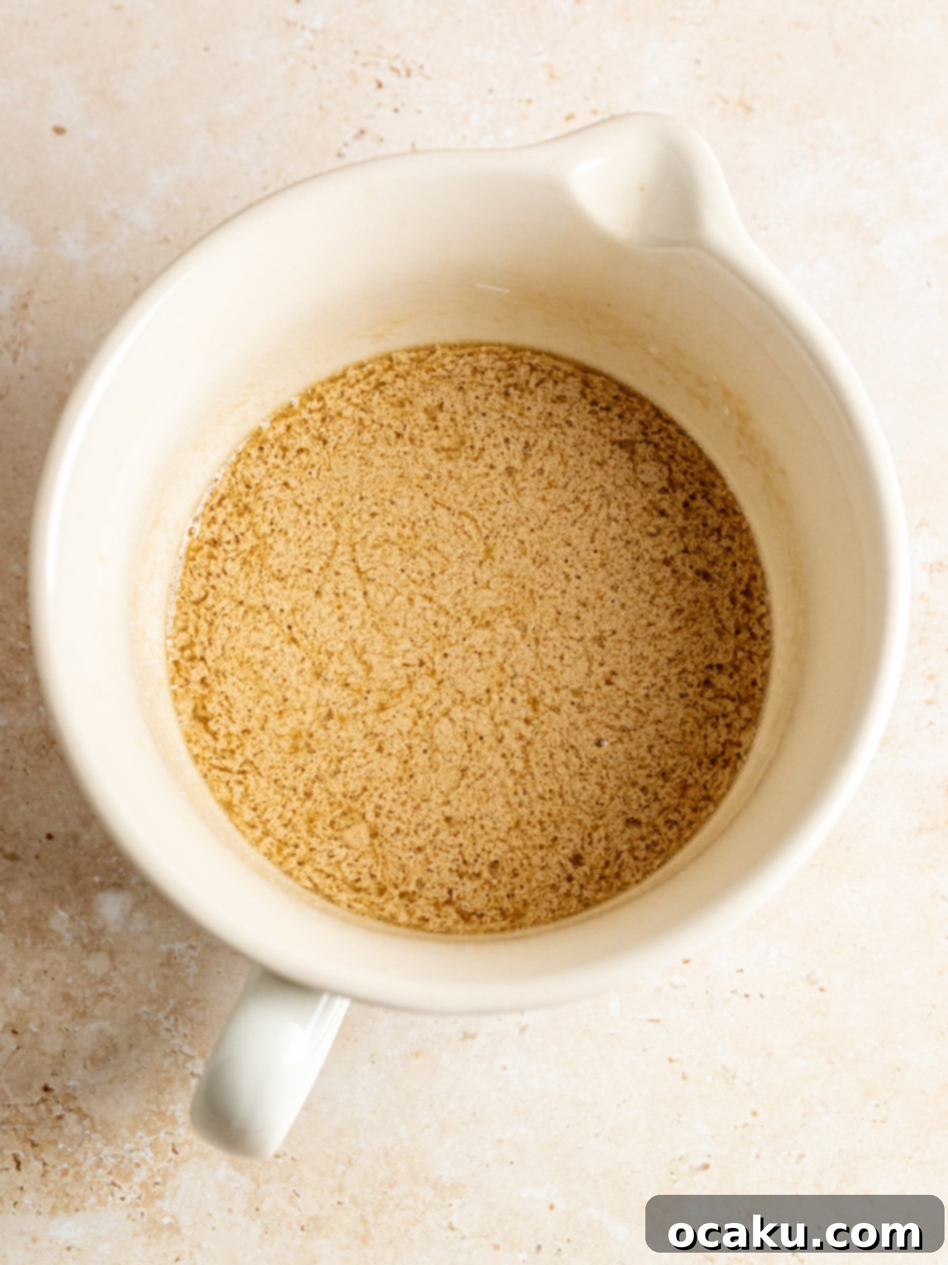Wet ingredients being whisked together in a separate bowl, including coffee.