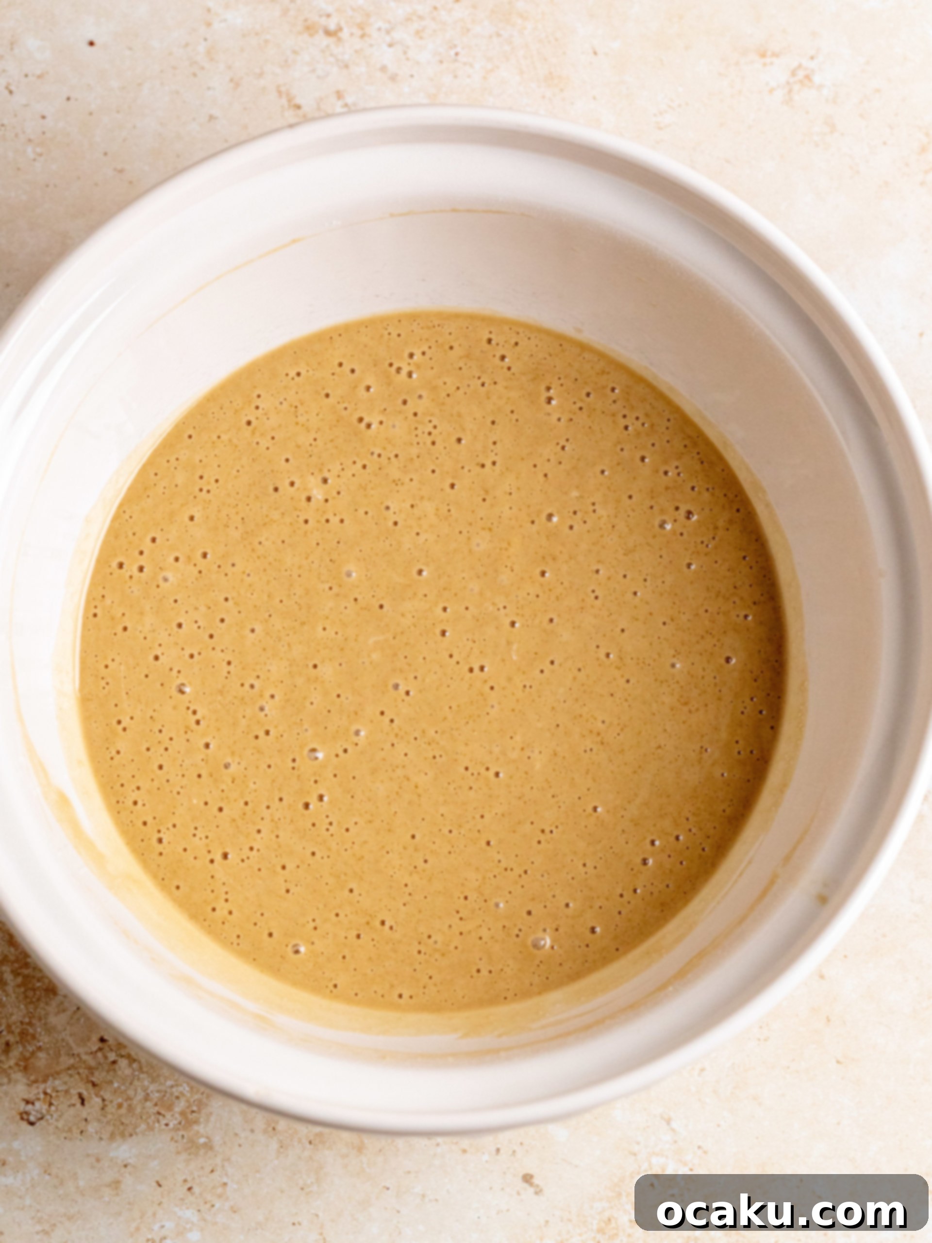 Butter being creamed in a stand mixer for the coffee buttercream.