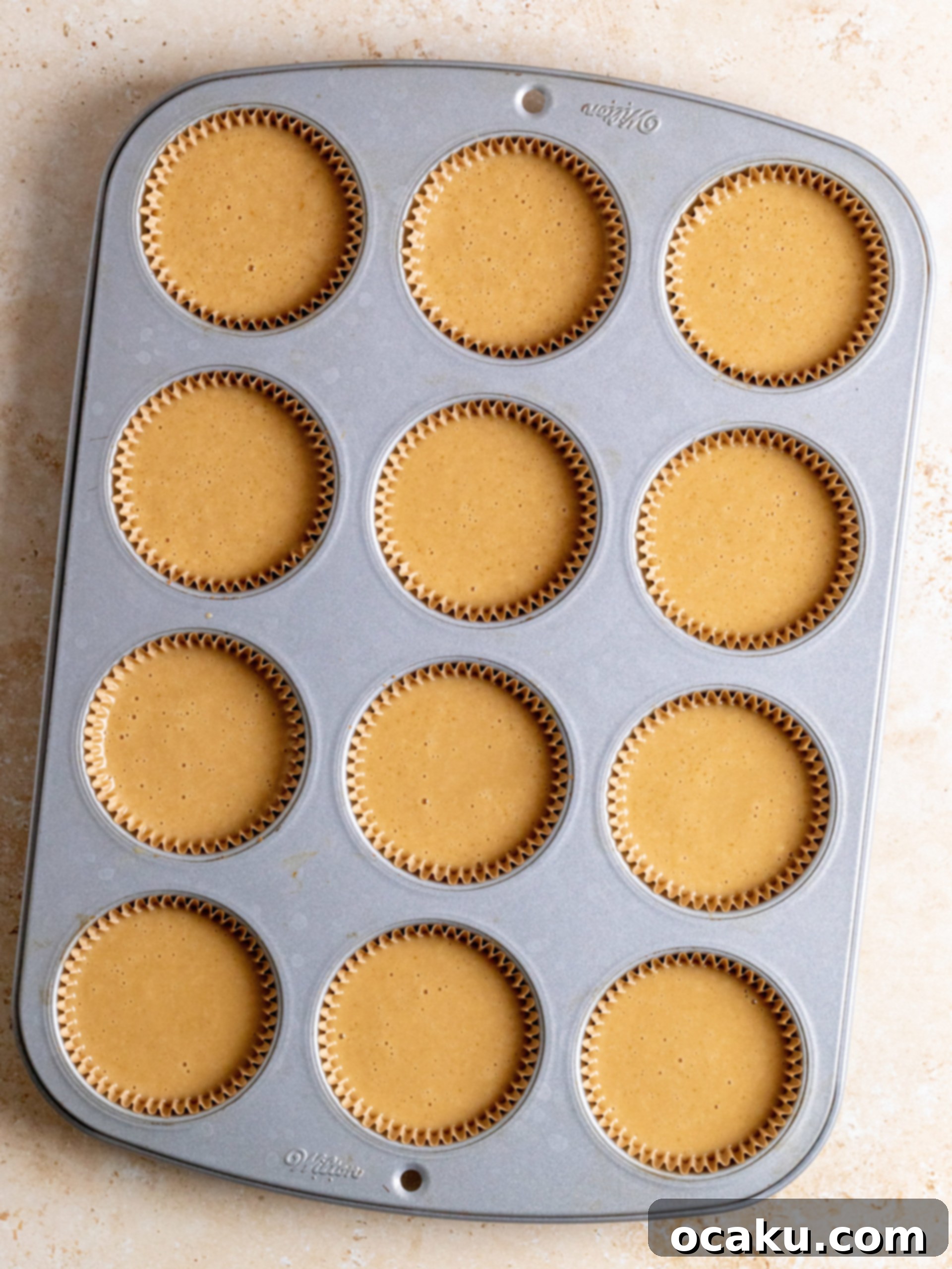 Powdered sugar being added to the creamed butter in stages for the buttercream.