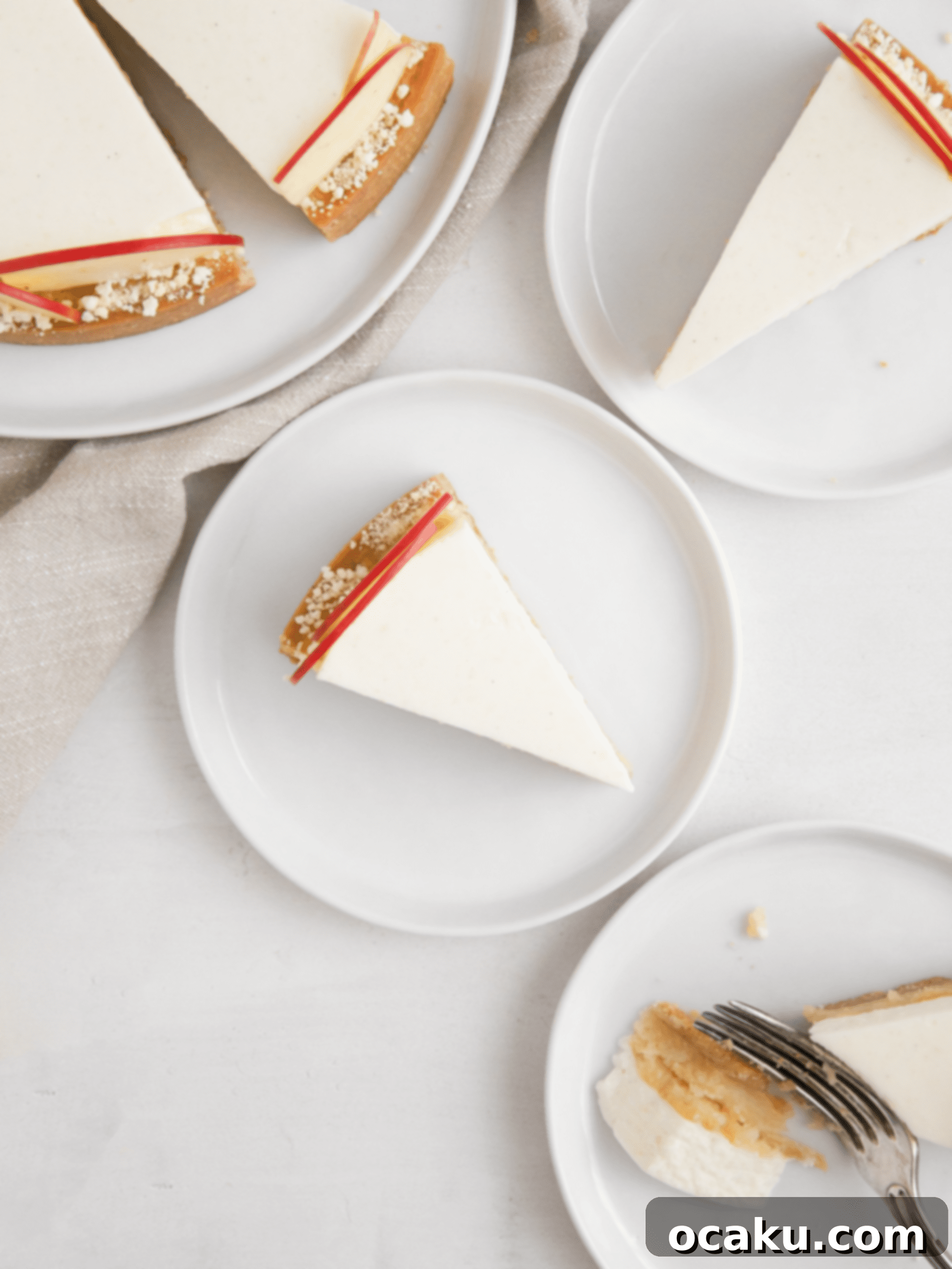 Individual slices of apple mousse tart on white plates, ready to be served.