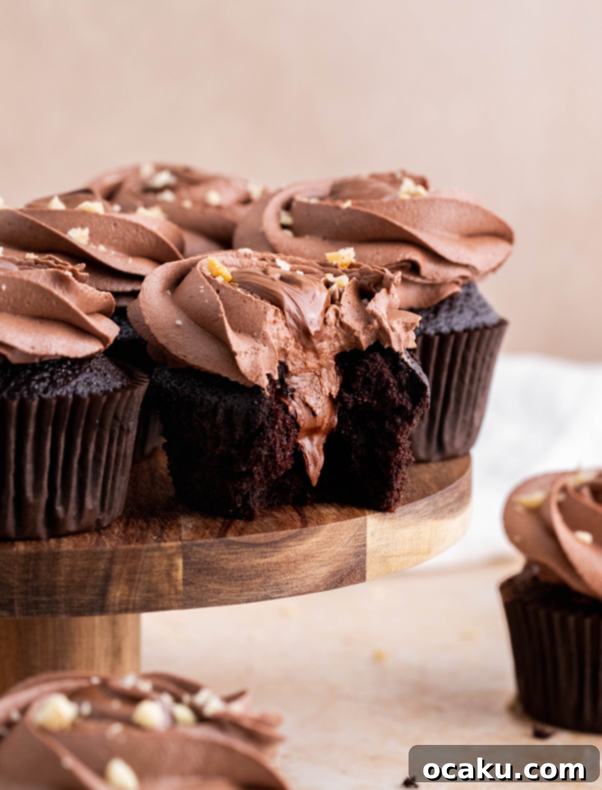 Close-up of a stack of Nutella cupcakes, showcasing the generous frosting and hazelnut topping.