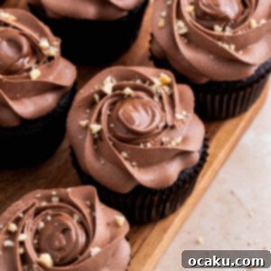 Final plated Nutella cupcake with generous frosting and chopped hazelnuts, ready to be enjoyed.