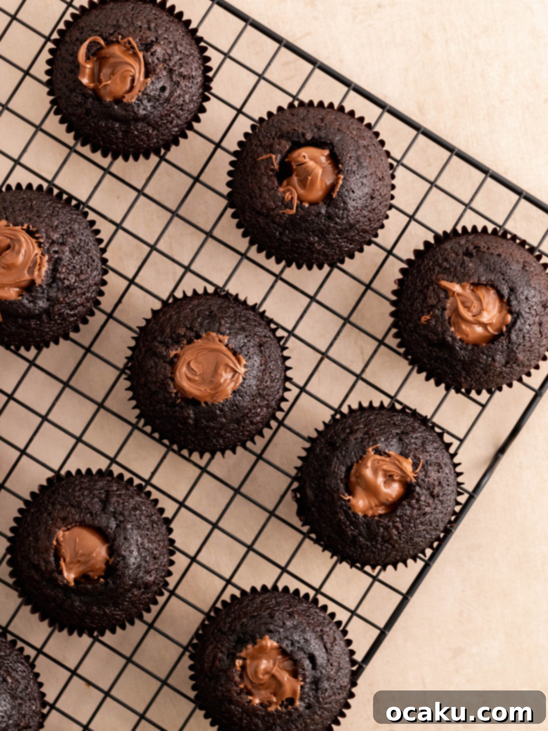 Adding Nutella to the creamy buttercream mixture in a stand mixer.