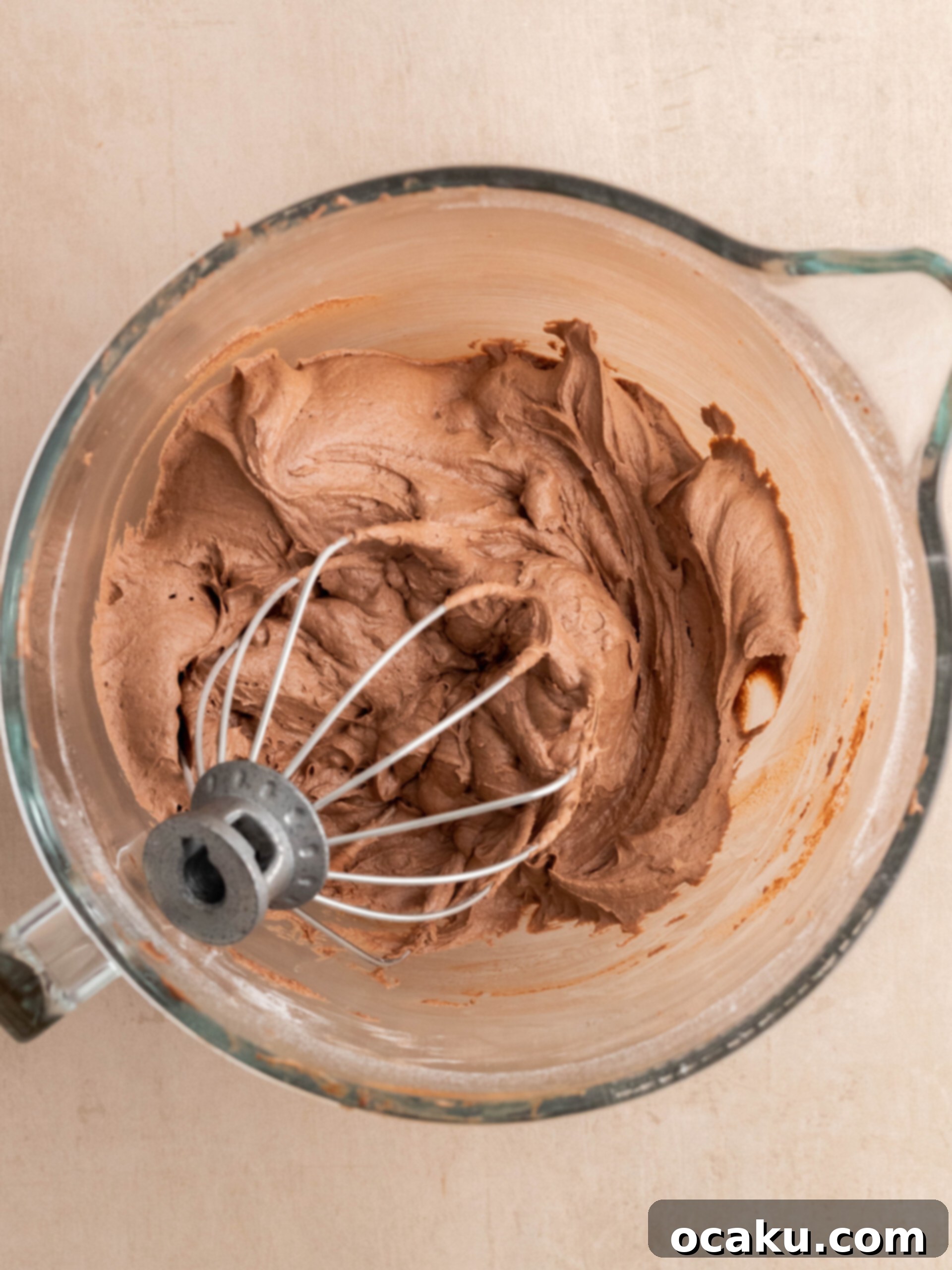 Piping Nutella filling into the cored centers of chocolate cupcakes.