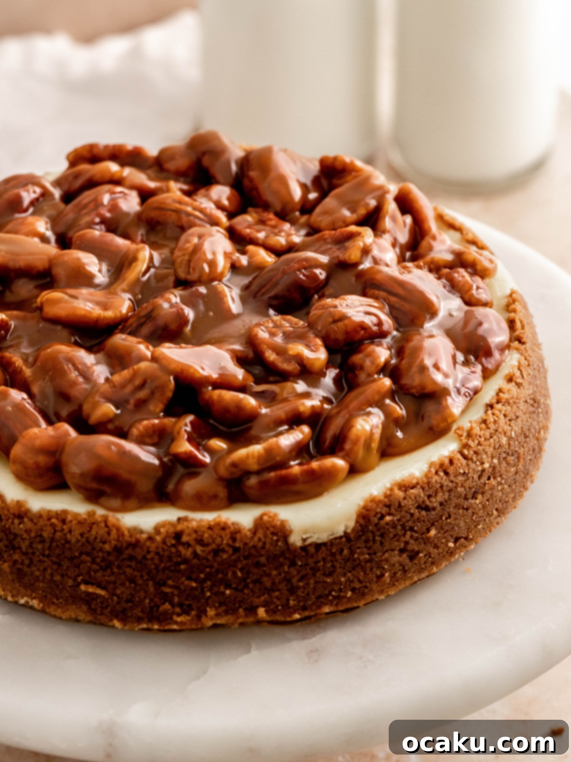 Step-by-step image showing the finished Caramel Pecan Cheesecake with caramel and pecans generously spread on top.