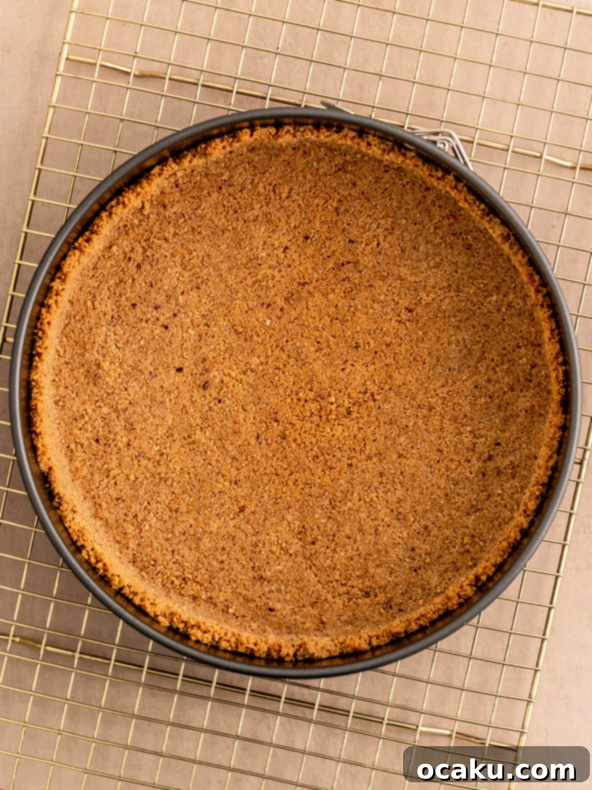 Step-by-step image showing the cookie crumb mixture pressed into a springform pan, forming the crust.
