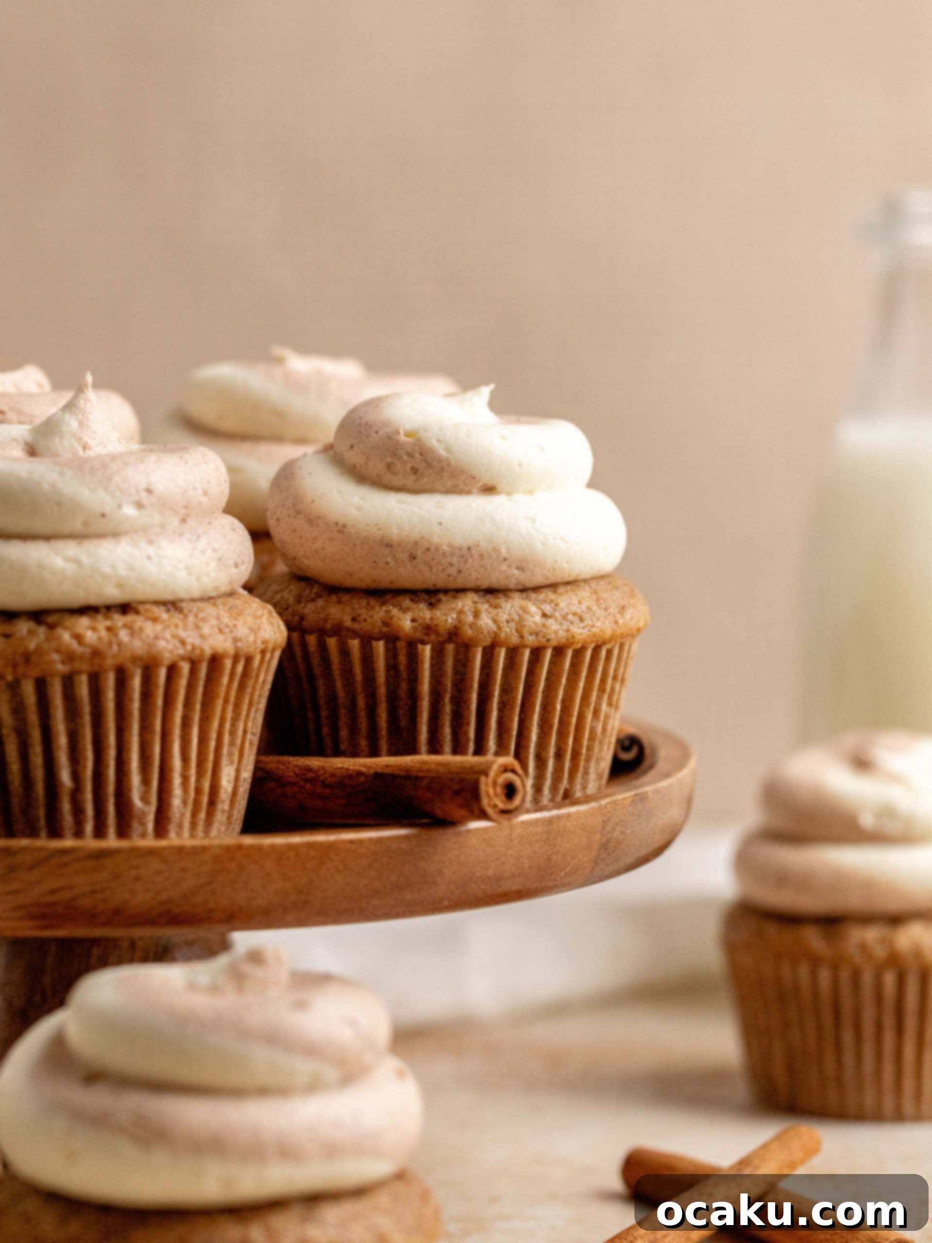Decadent Cinnamon Cupcakes 2 A perfectly baked cinnamon cupcake topped with swirled vanilla and cinnamon buttercream, ready to be enjoyed.