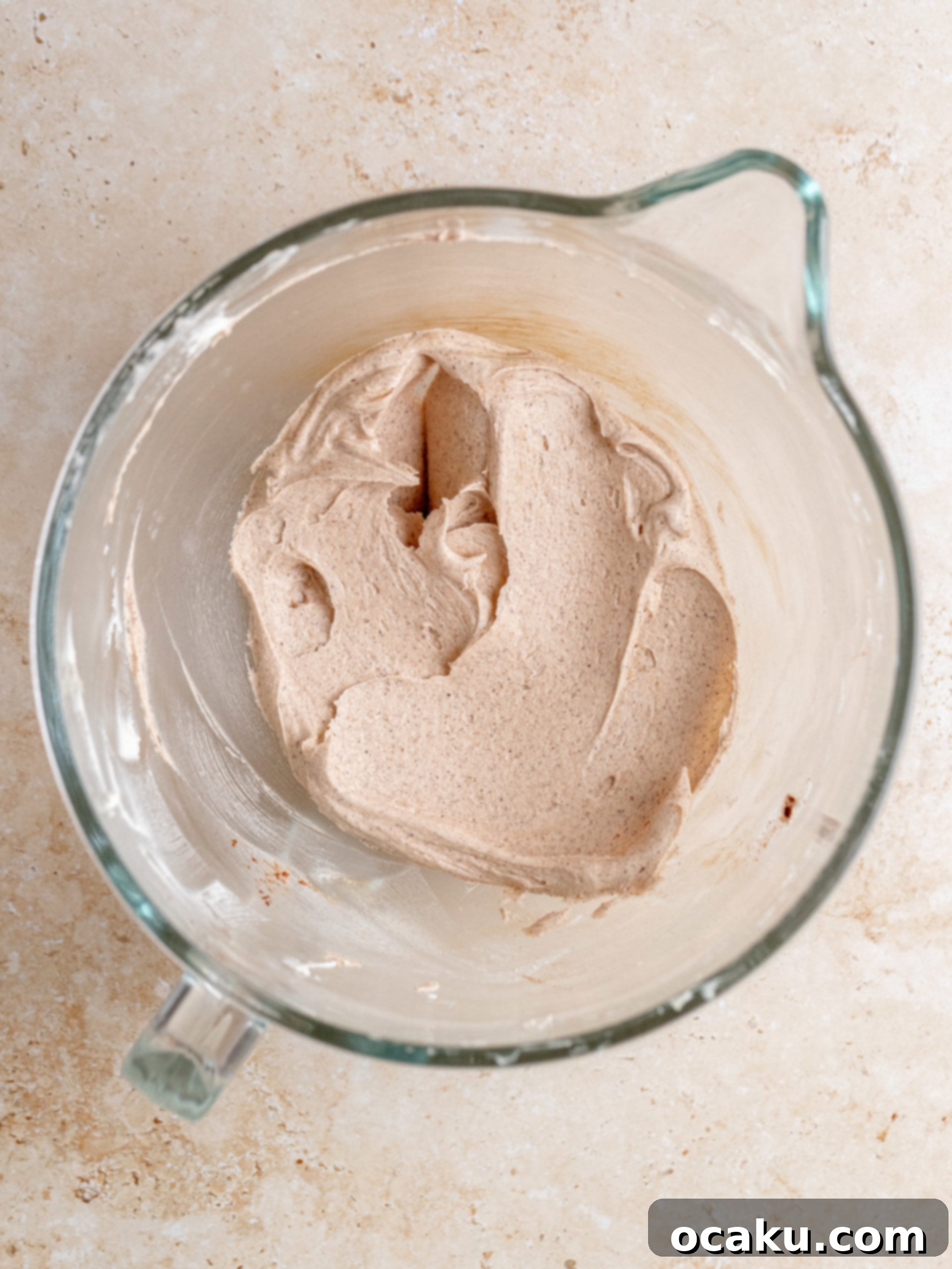 Decadent Cinnamon Cupcakes 8 Buttercream frosting being mixed in a stand mixer, smooth and ready for flavoring.