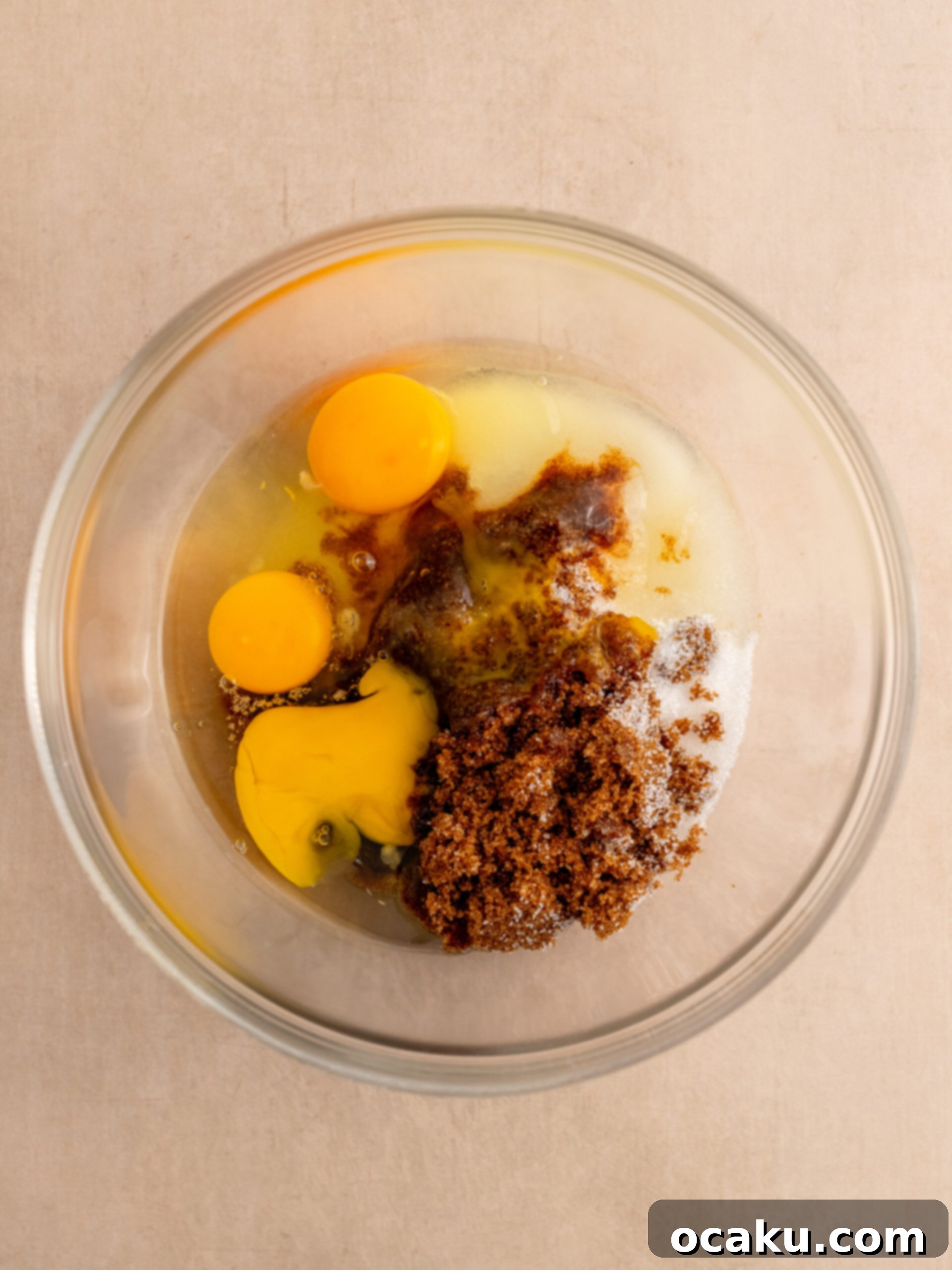 Step 1: Add room temperature eggs and both sugars to a mixing bowl.