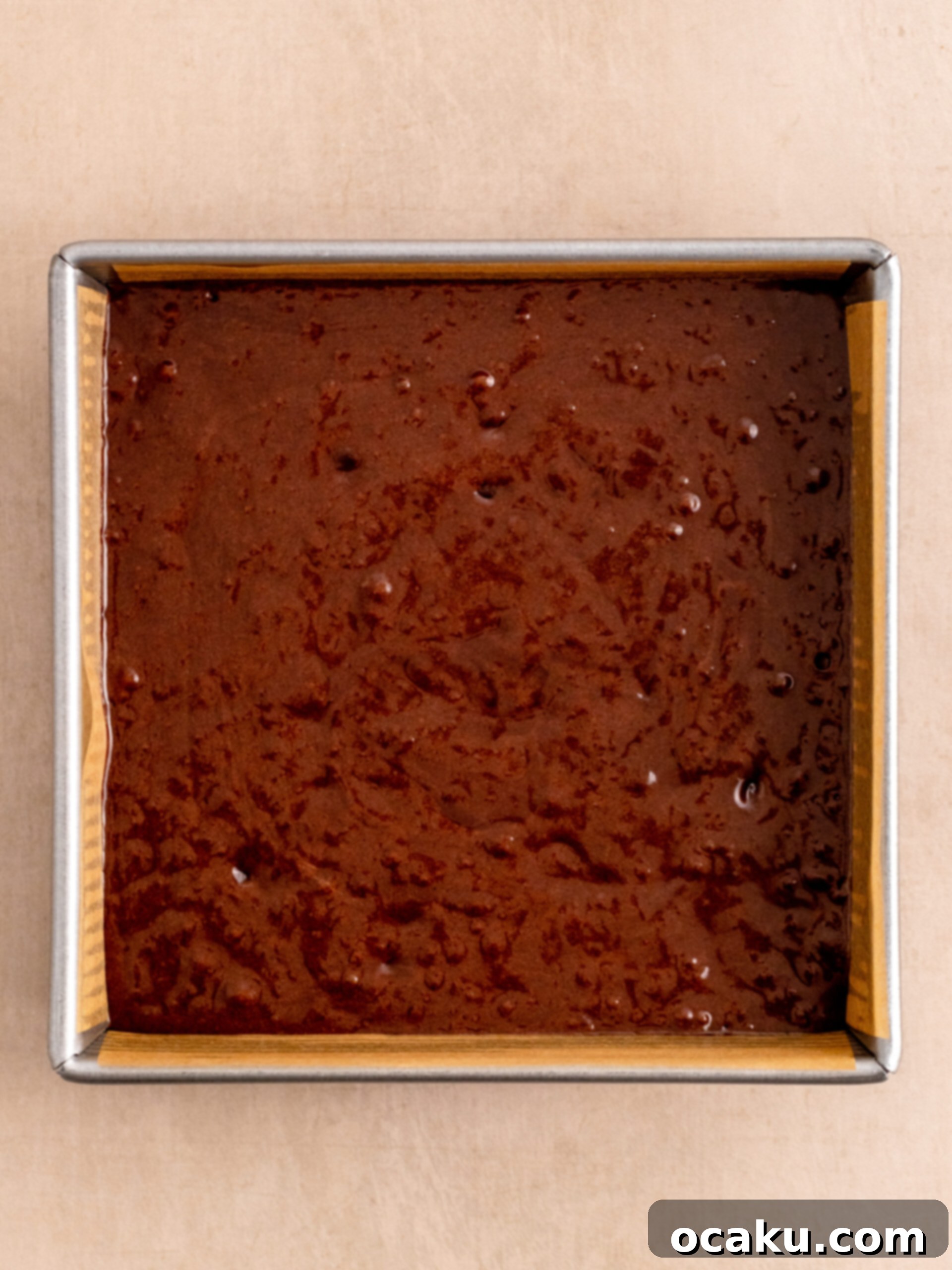 Step 5: Pour the brownie batter into the prepared baking pan with parchment paper and bake until set.