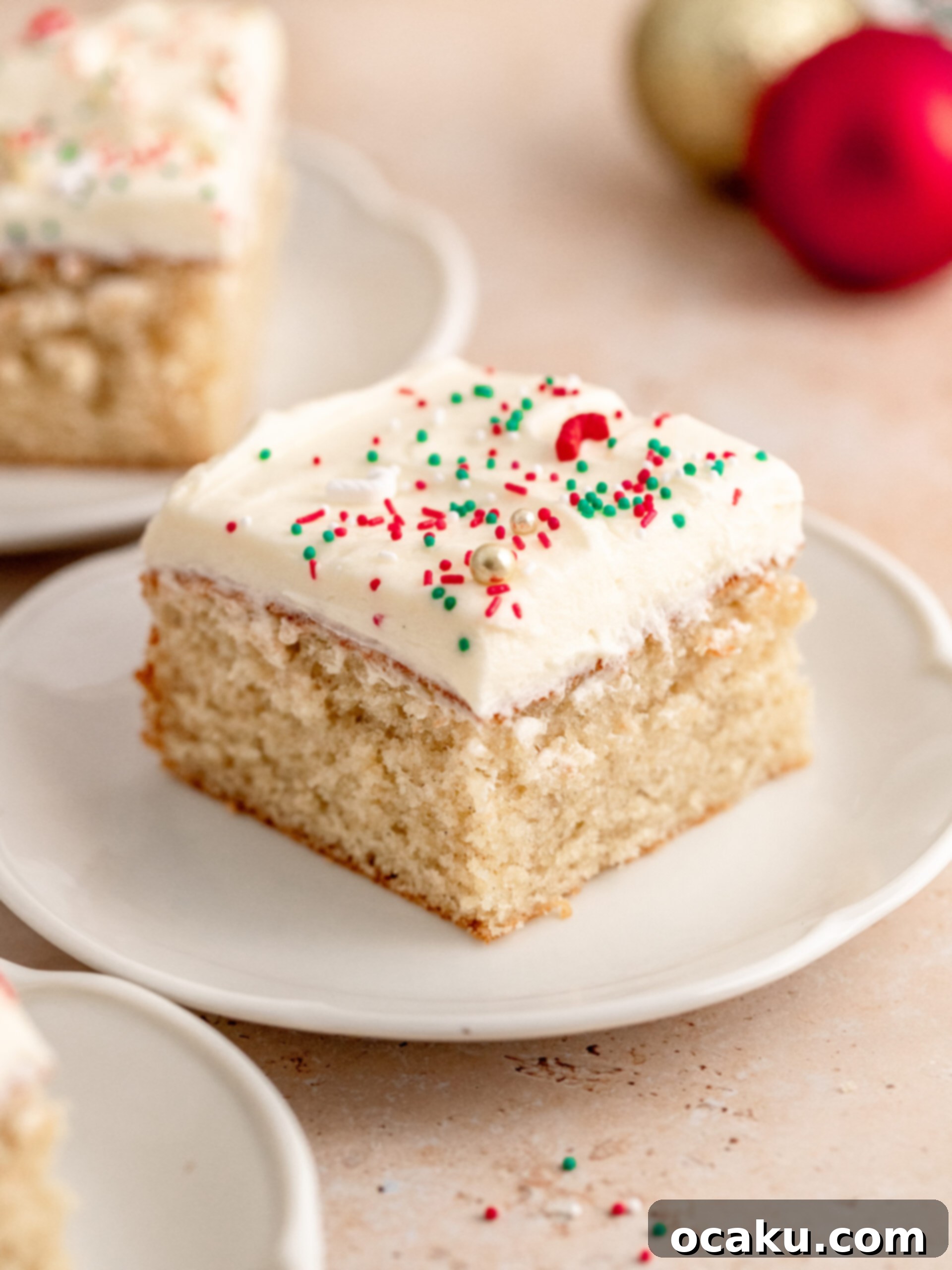A perfectly sliced piece of cardamom cake on a plate.