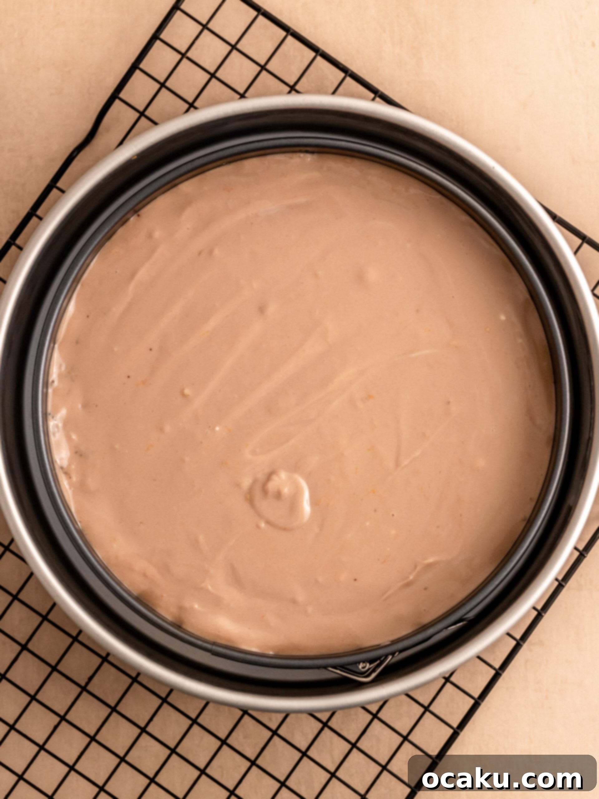 Decadent Chocolate Orange Cheesecake 6 Pouring cheesecake batter into the crust-lined springform pan.