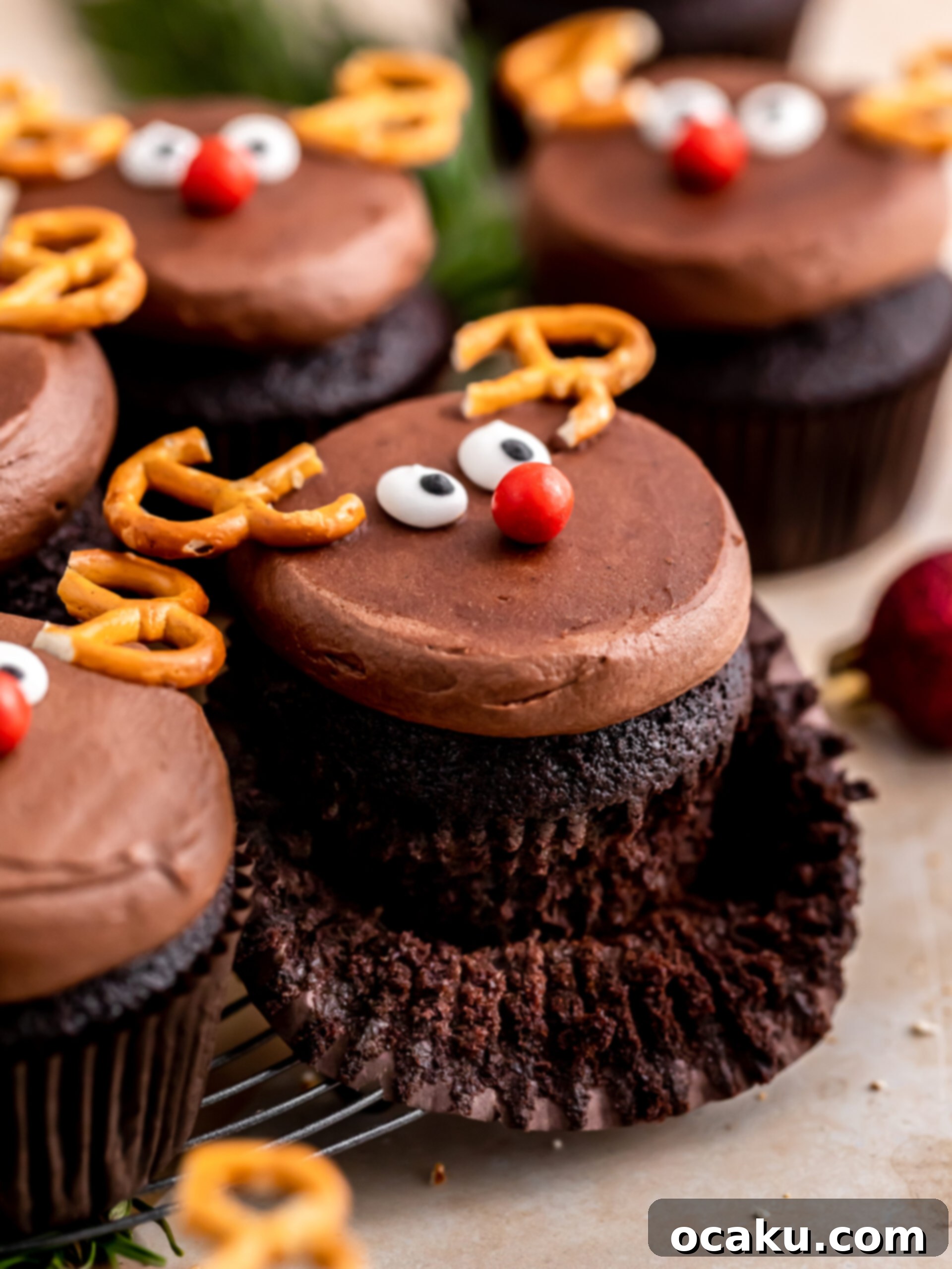 A tray of freshly baked chocolate reindeer cupcakes, cooling on a wire rack.