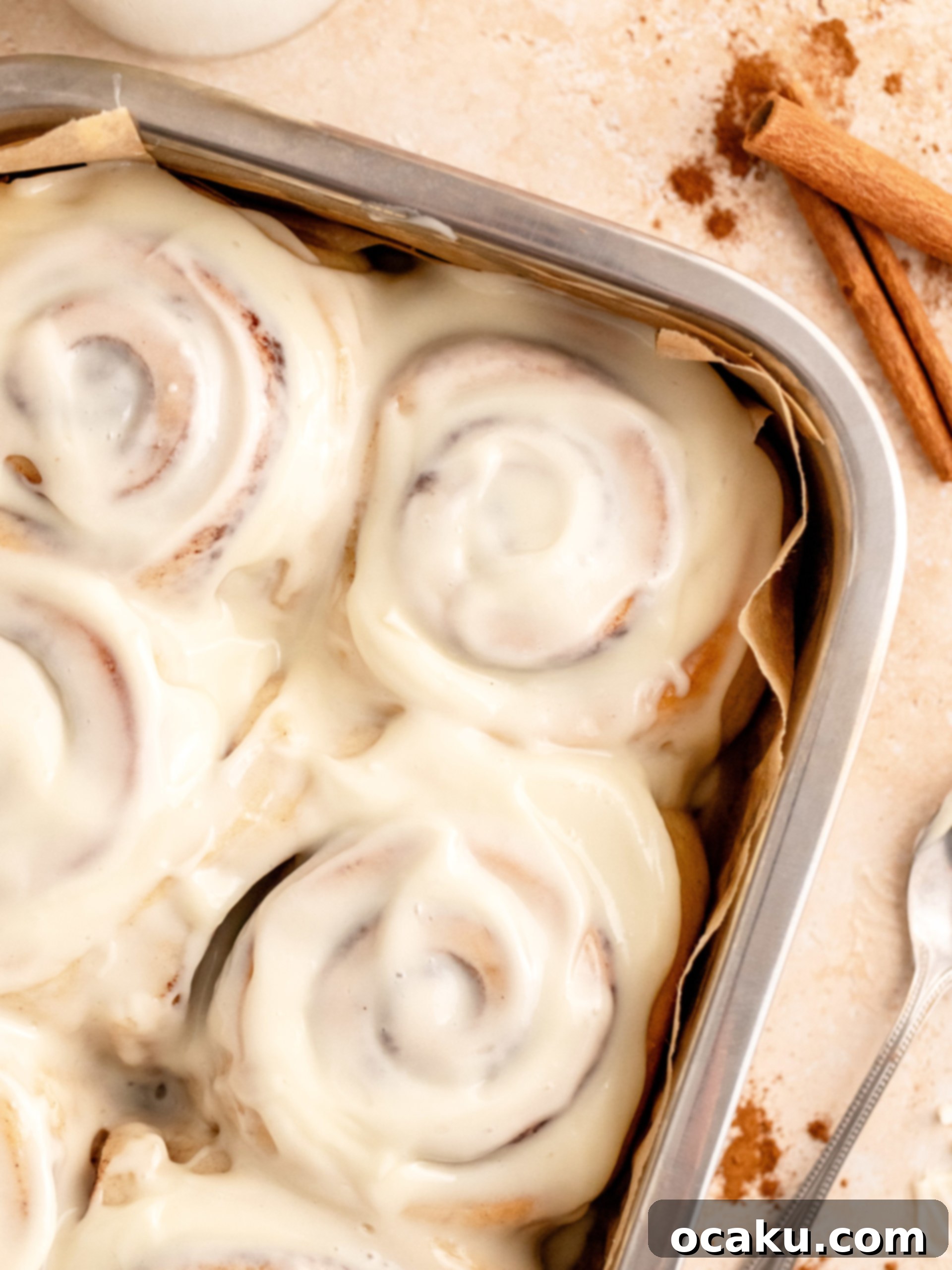 Perfectly Sized Cinnamon Rolls 11 A small batch of cinnamon rolls, perfectly baked and frosted, showcased on a cooling rack.
