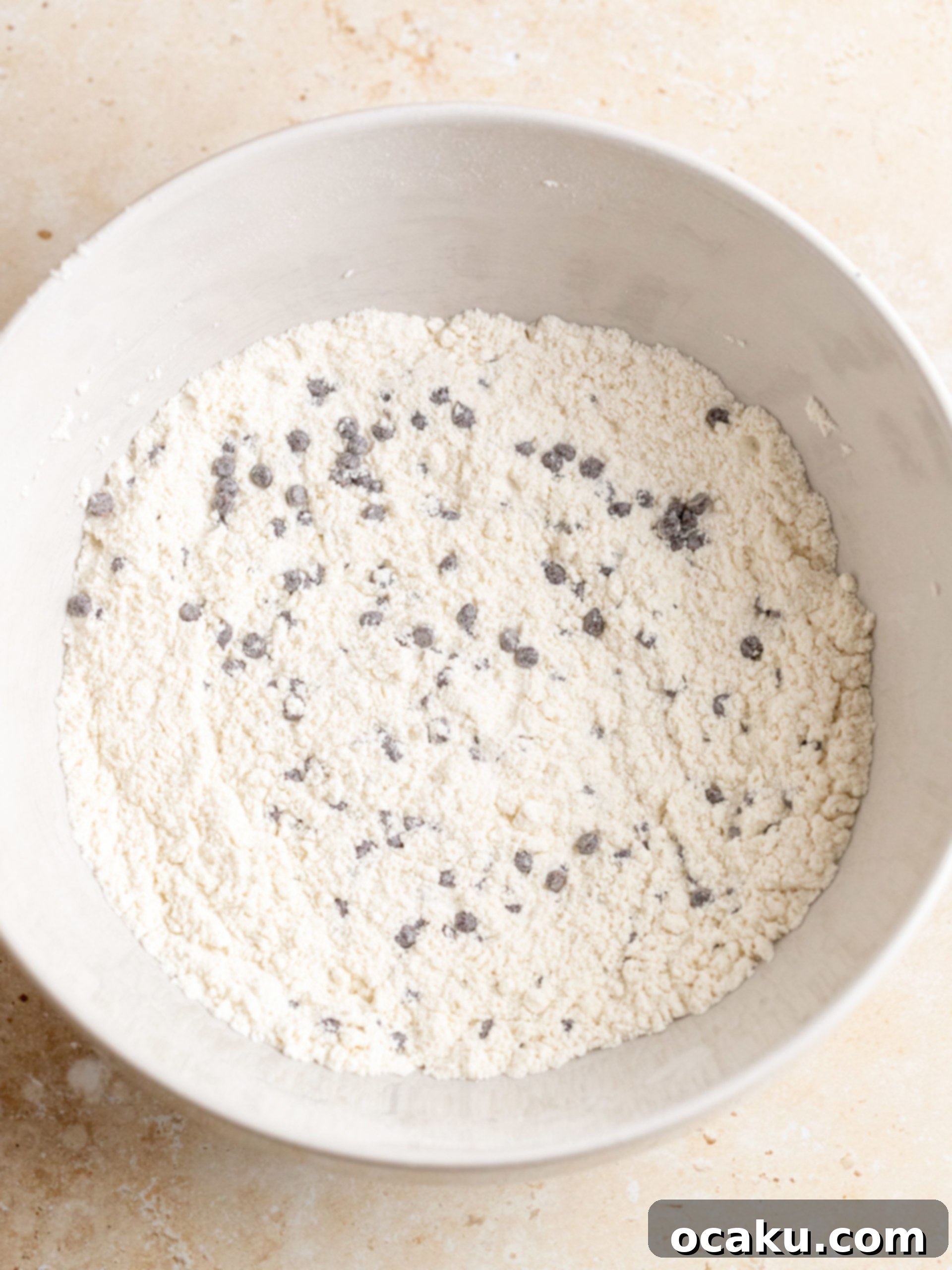 Image showing dry ingredients being mixed with chocolate chips in a bowl.