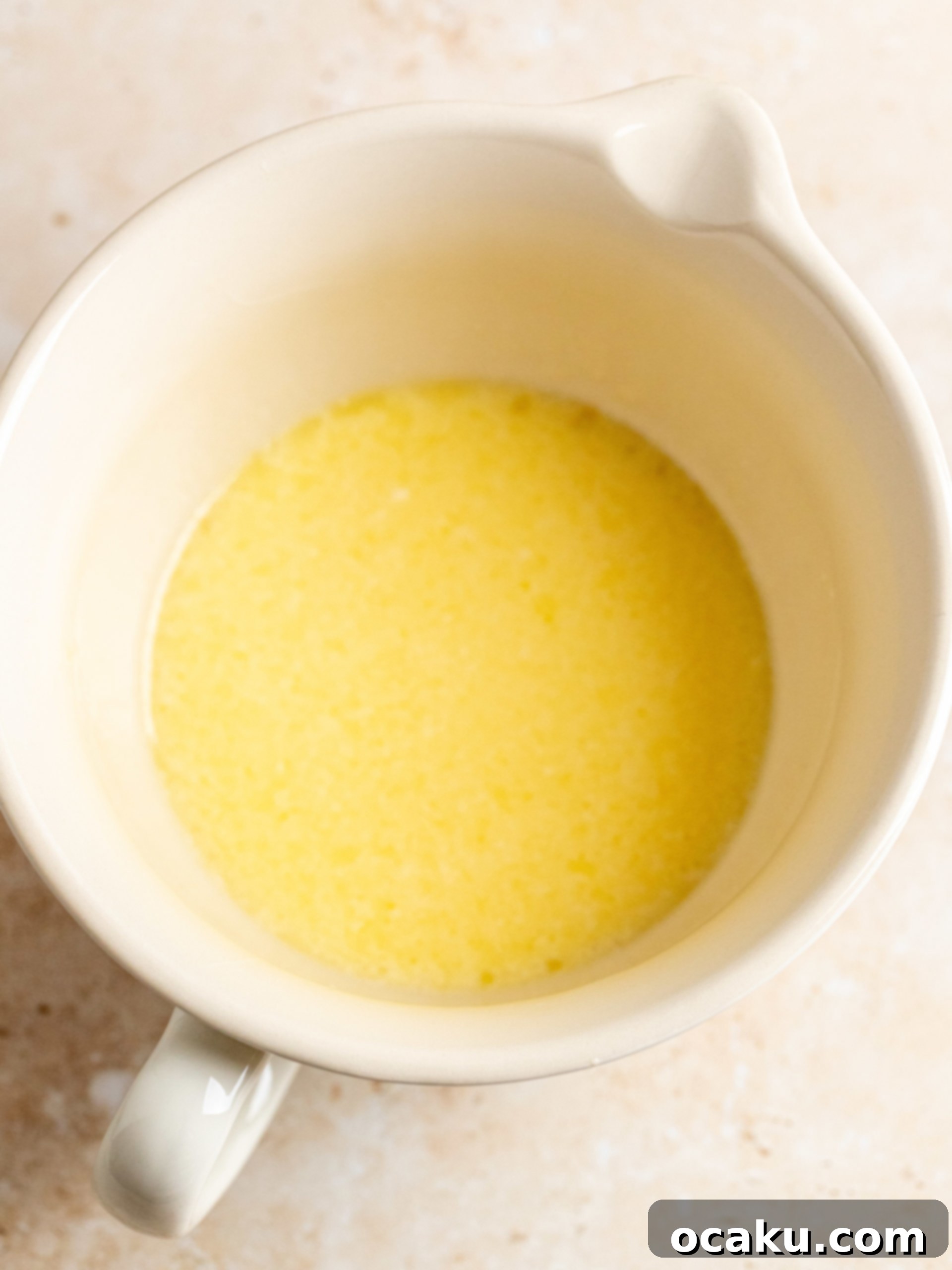 Image showing wet ingredients being whisked together in a separate bowl.