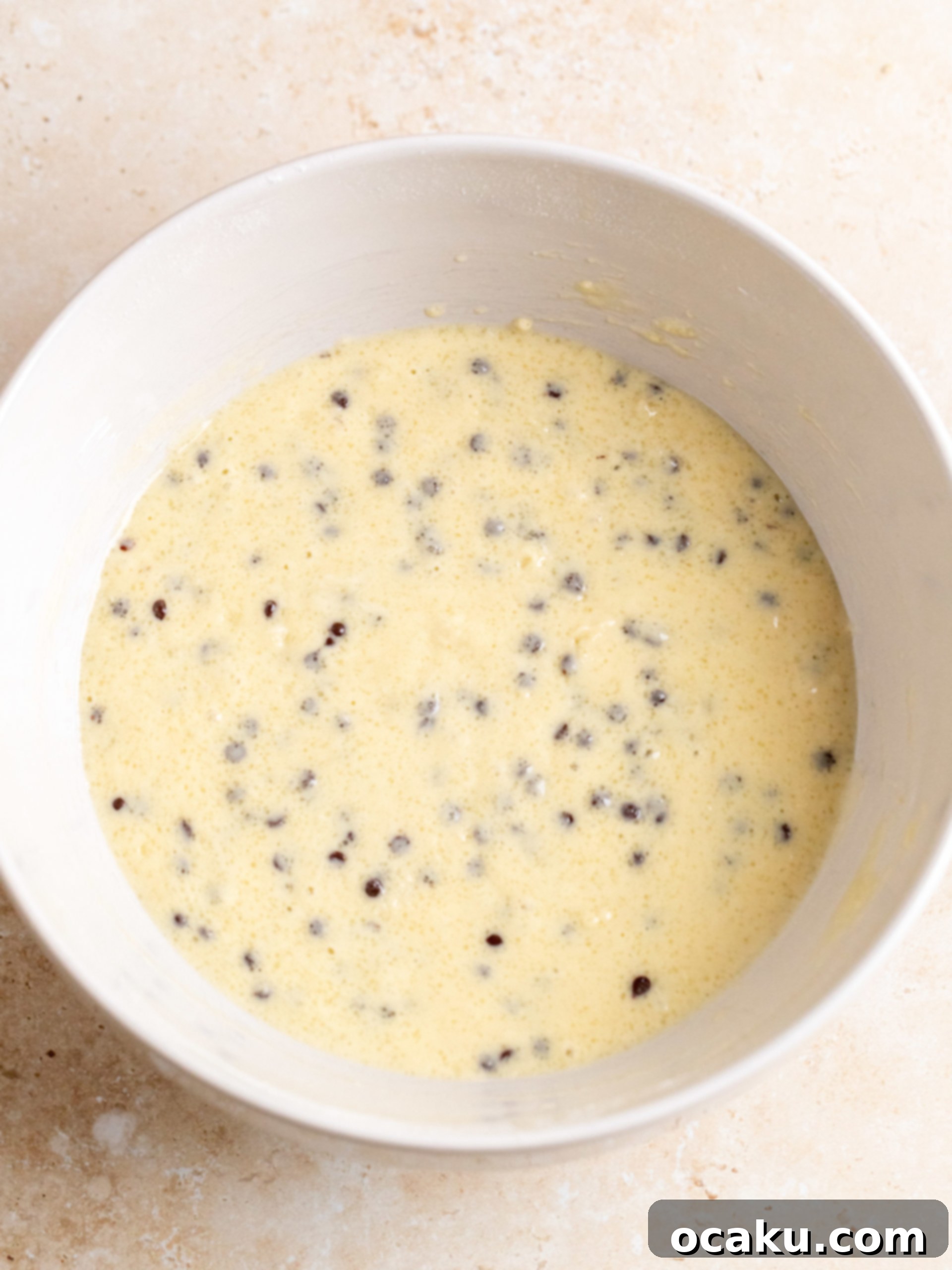 Image showing muffins being scooped into liners, filled to the top.